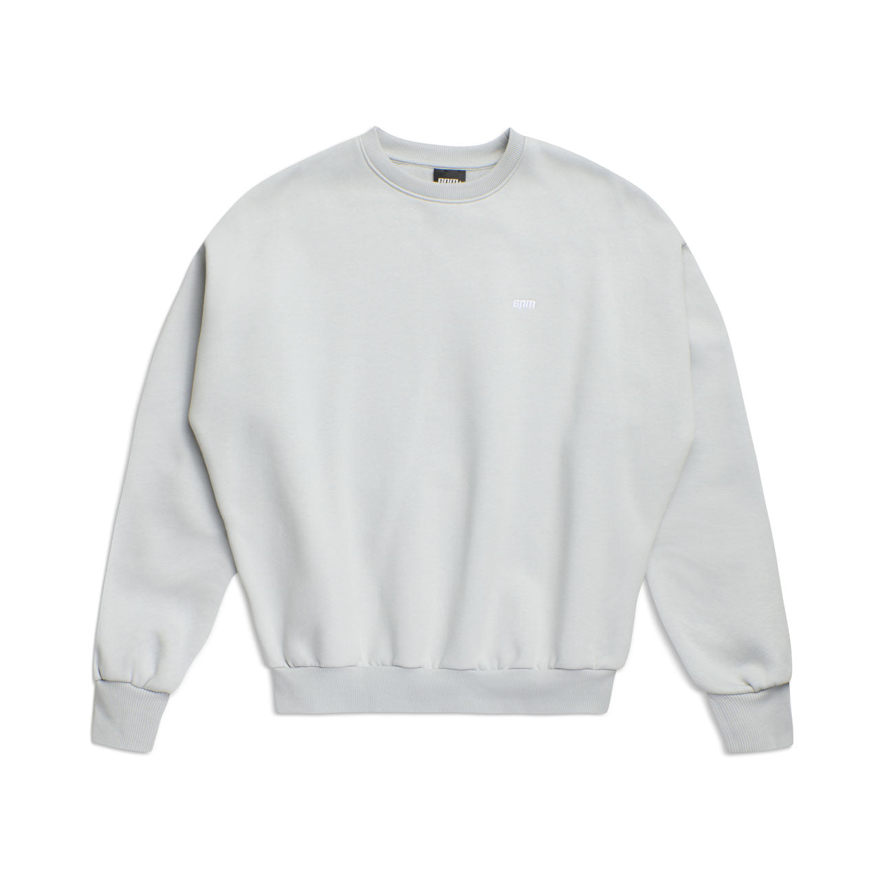 The 6PM CREWNECK SMOKE GREY is a light gray, boxy-fit sweatshirt featuring long sleeves, ribbed cuffs and hem, and a small logo on the left chest for a simple, minimalistic look.