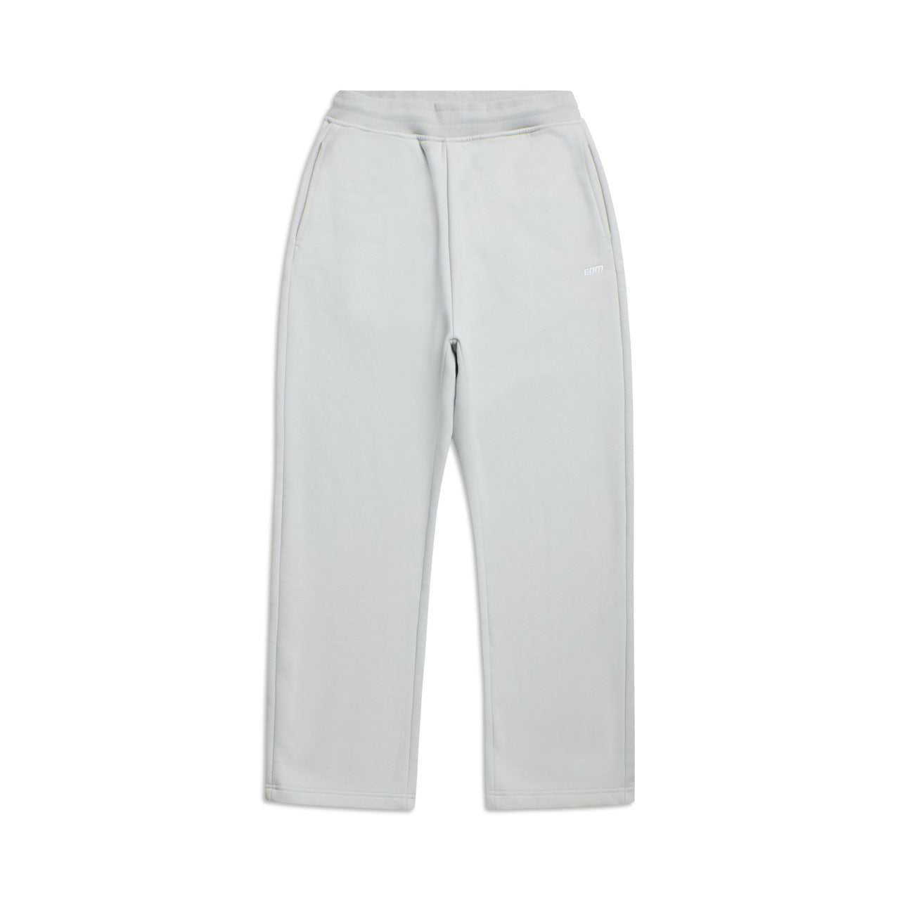 The OPEN LEG JOGGER SMOKE GREY features straight legs, an elastic waistband, and side pockets for a modern classic look; shown laid flat on a white background.