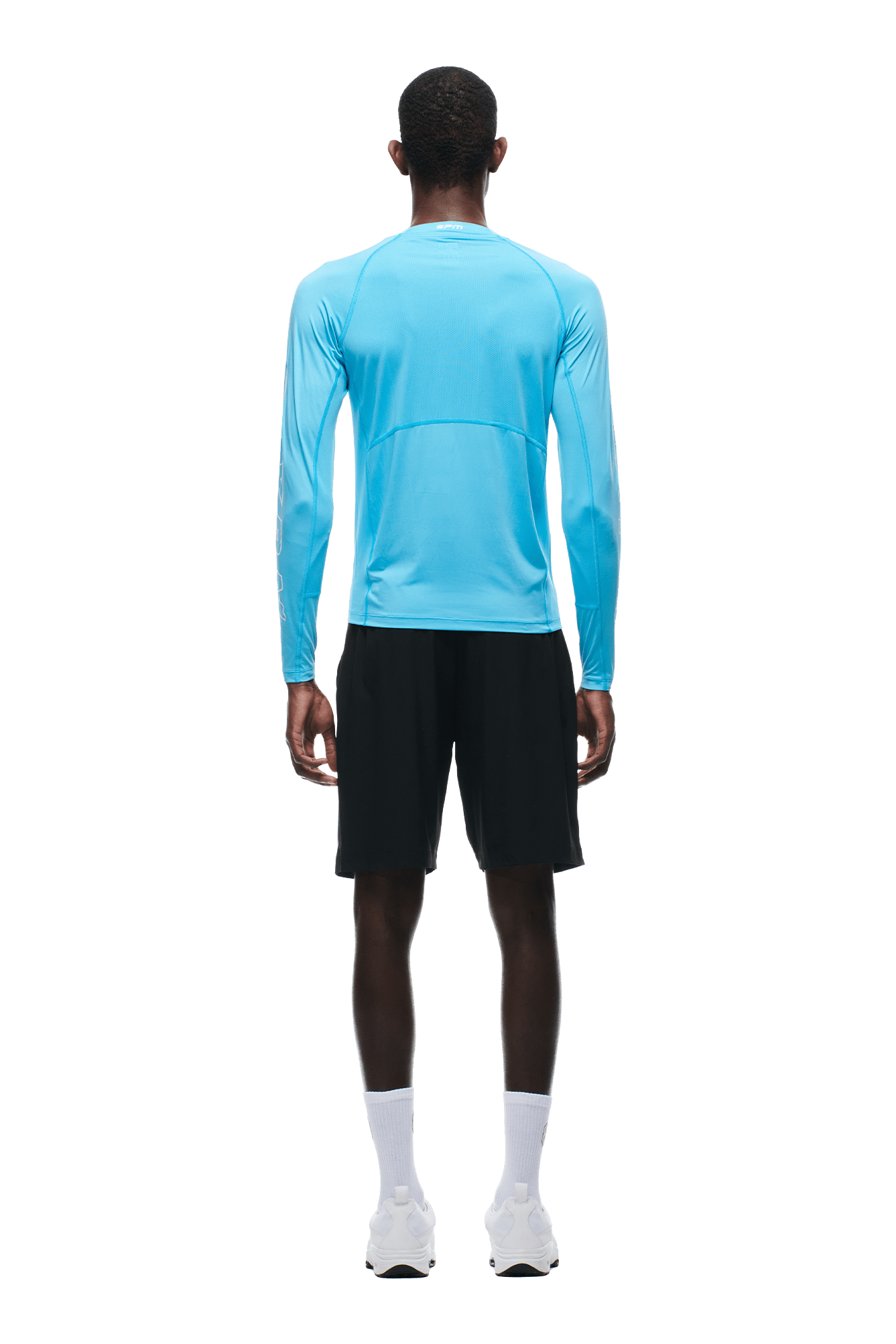 A man faces away, wearing the 6PM SPORTS LONGSLEEVE AQUA BLUE by 6PM, paired with black shorts, white crew socks, and white sneakers on a transparent background.