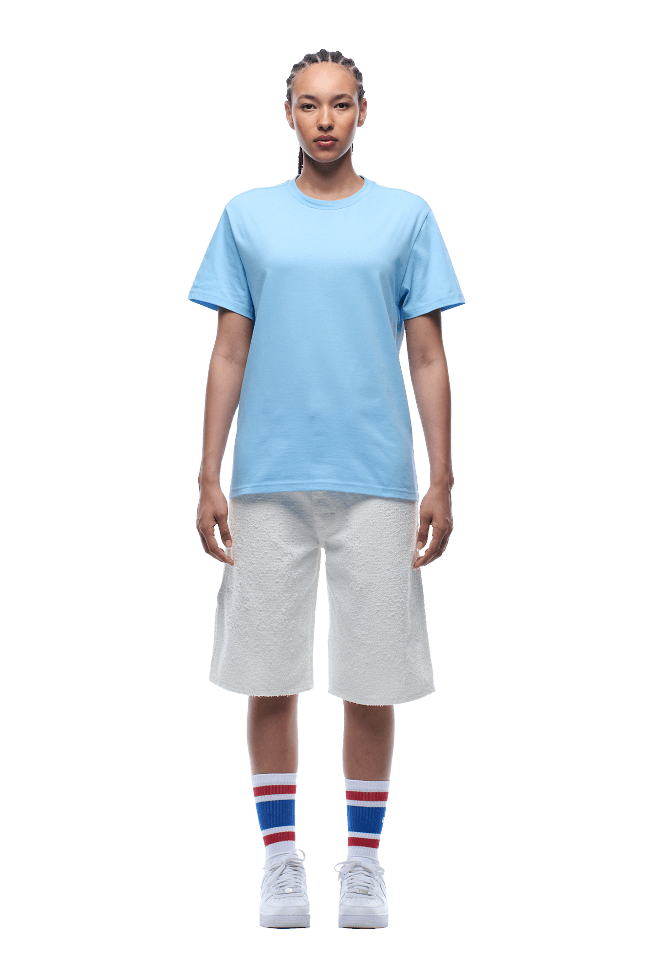 Person standing facing forward, wearing the 6PM COLLEGE STAR TEE BLUE, white knee-length shorts, white sneakers, and white socks with red and blue stripes on a transparent background.