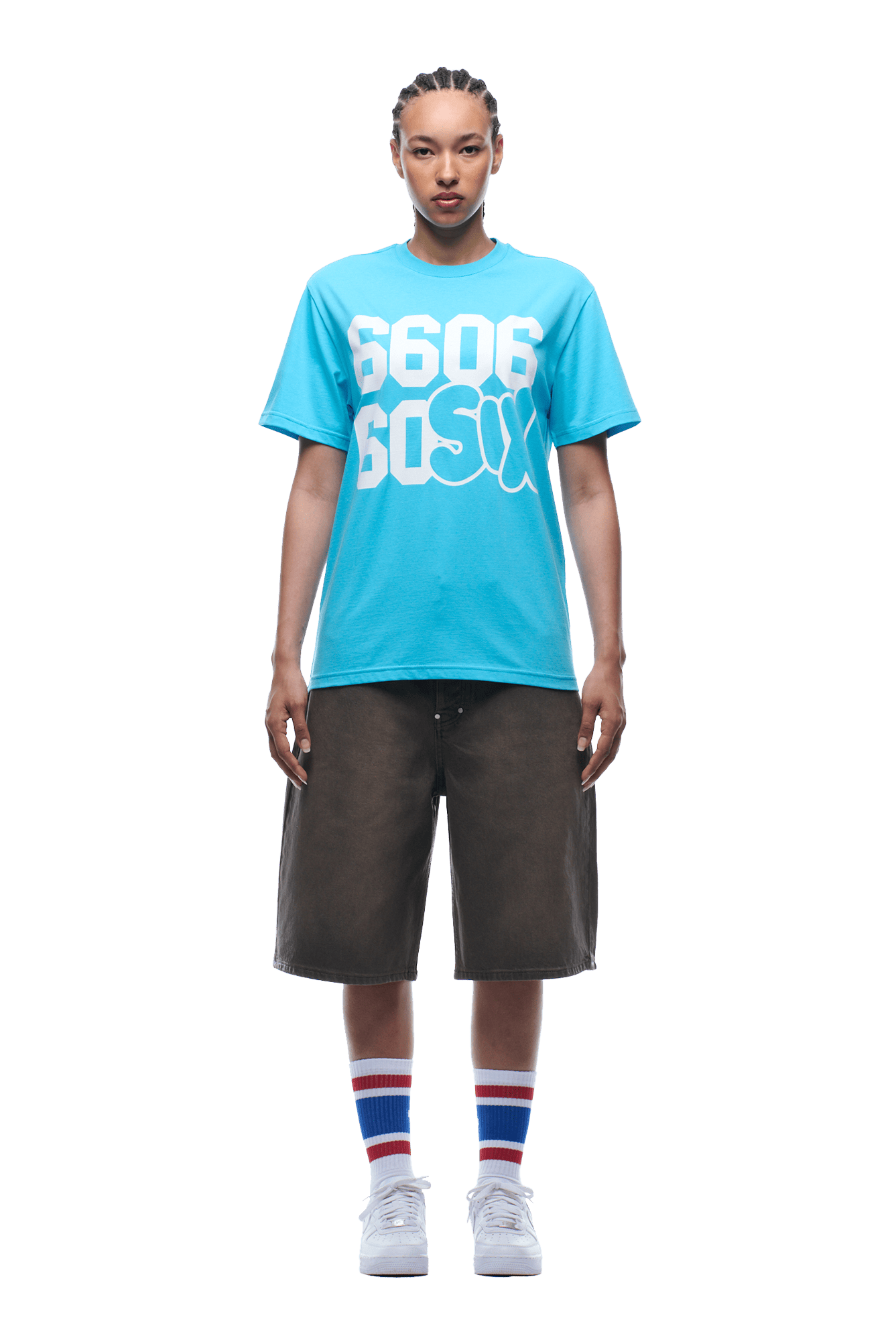 A person with braided hair faces forward, wearing the 6PM 660660 TEE BLUE, black knee-length shorts, striped socks, and white sneakers. Background is transparent.