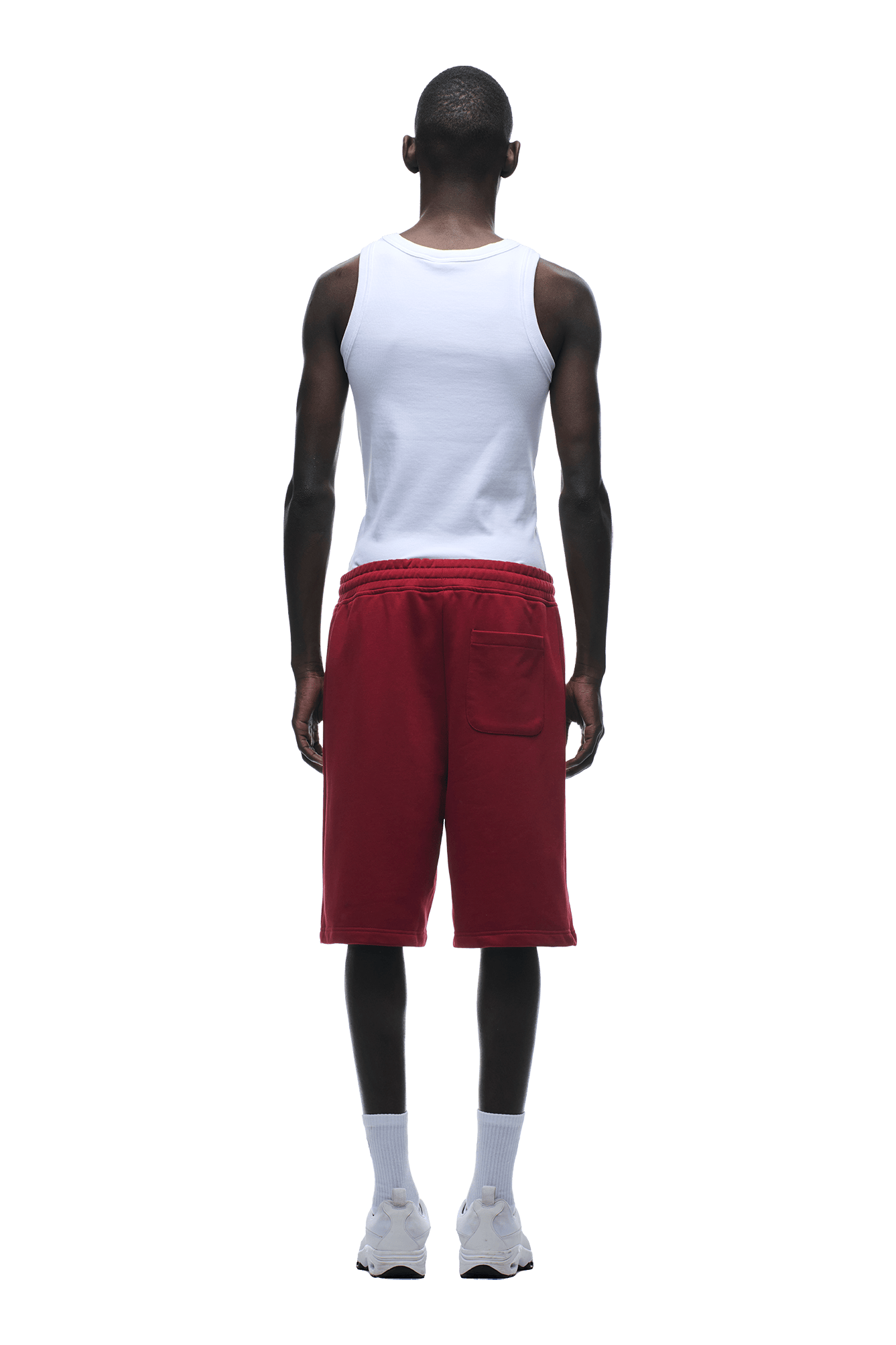A person faces away, wearing a relaxed fit white tank top, 6PM 6PM+ SHORTS WINE RED with a drawstring waist, white socks, and white sneakers on a transparent background.
