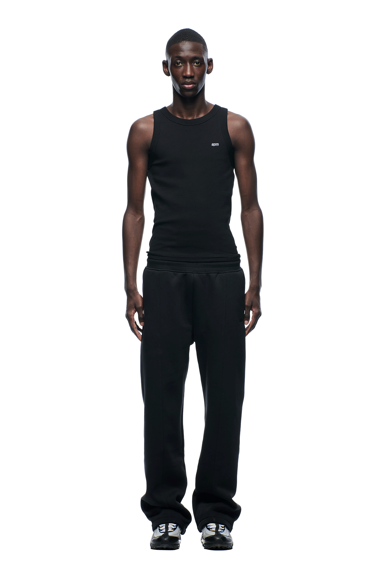 A person stands facing forward against a white background, wearing the 6PM 6PM+ SLIM FIT JOGGER in faded black with a tapered silhouette and relaxed fit, crafted from heavyweight cotton for ultimate comfort. Their arms rest by their sides.