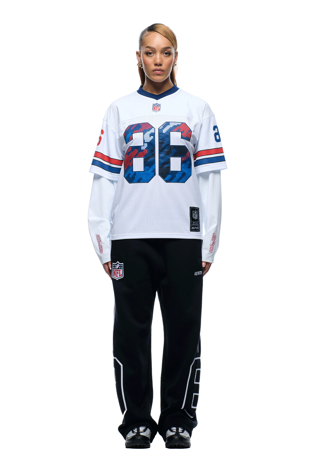 A person faces forward wearing the 6PM NFL LAYERED MESH LONGSLEEVE WHITE football jersey with the number 86, paired with black pants featuring white numbers and black sandals, all set against a plain white background.