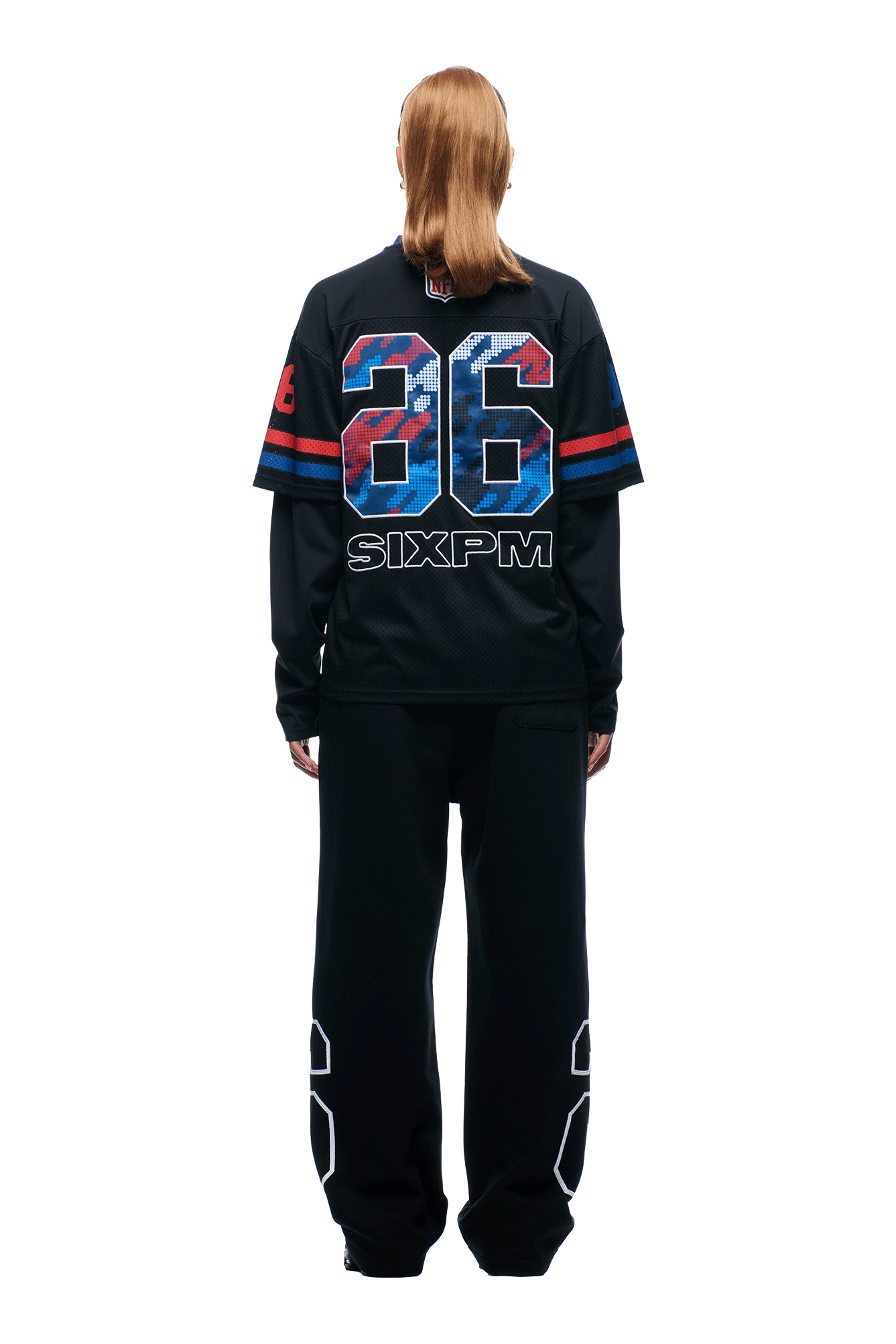 A person with straight, shoulder-length hair stands facing away, wearing the 6PM NFL Layered Mesh Longsleeve Black jersey with "26" and "SIXPM" on the back, paired with black pants featuring "26" on the lower legs, against a plain white background.