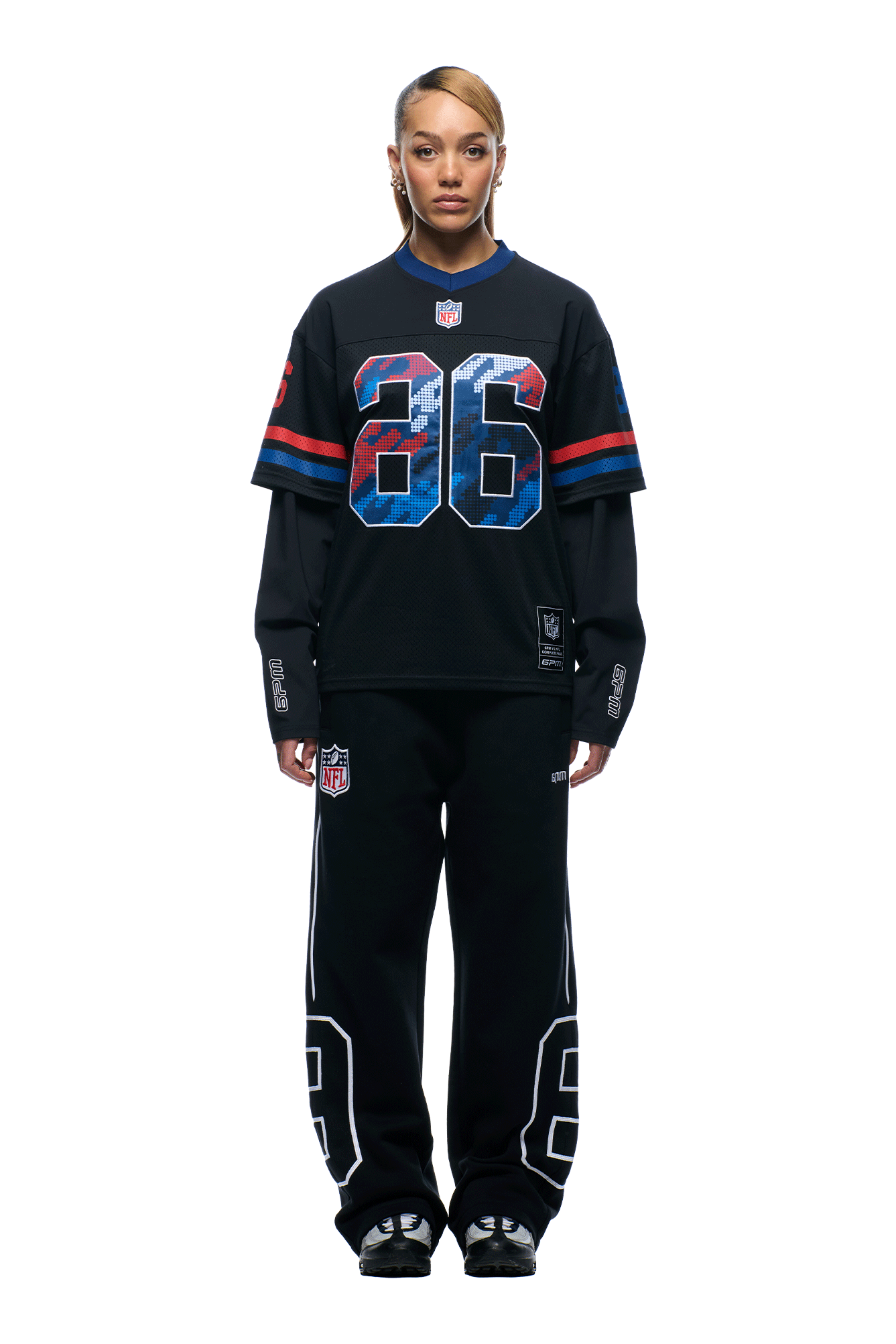 A person faces forward wearing the 6PM NFL LAYERED MESH LONGSLEEVE BLACK jersey with blue and red number 86, layered over a long sleeve, and matching black pants featuring the number 86 and NFL logos.