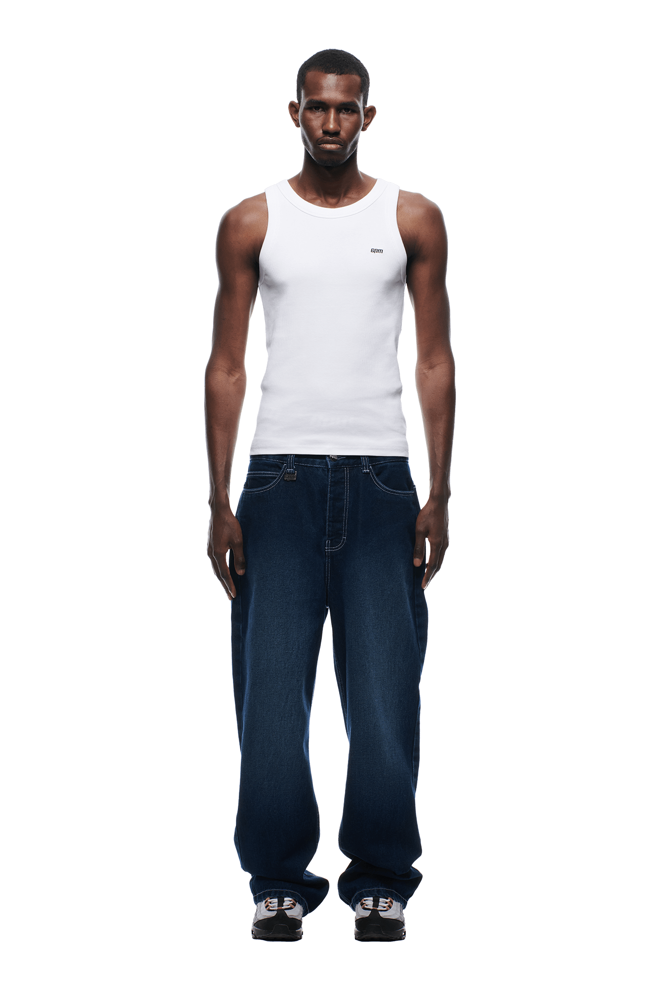 A man in a white tank top and 6PM SCRIPT LOGO DENIM WASHED DARK BLUE jeans.