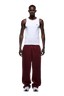 A man faces forward wearing a white tank top, 6PM OPEN LEG JOGGER WINE RED sweatpants with stacking length, and white sneakers. His arms are relaxed at his sides and he has a neutral expression. The background is transparent.