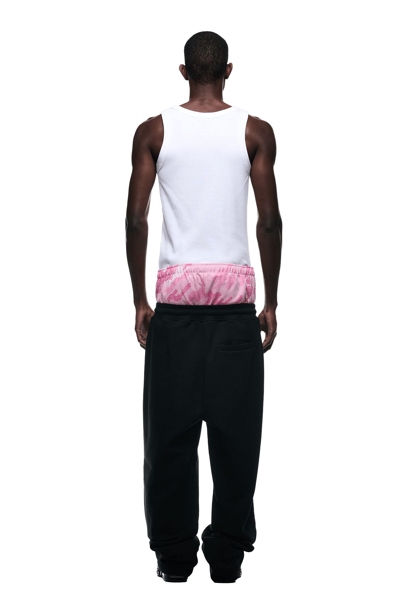 A person facing away from the camera wears a 6PM BOXERS OPEN LEG JOGGER BLACK with a white tank top and pink tie-dye underwear visible above the waistband. The background is plain white.
