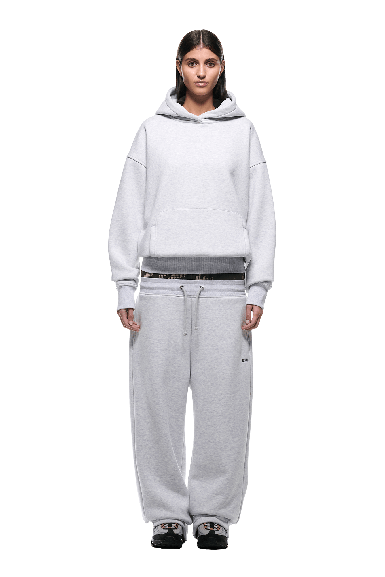 A person stands facing forward wearing the 6PM DOT CAMO LETTER HOODIE GREY with matching baggy sweatpants and black sneakers, set against a plain white background.