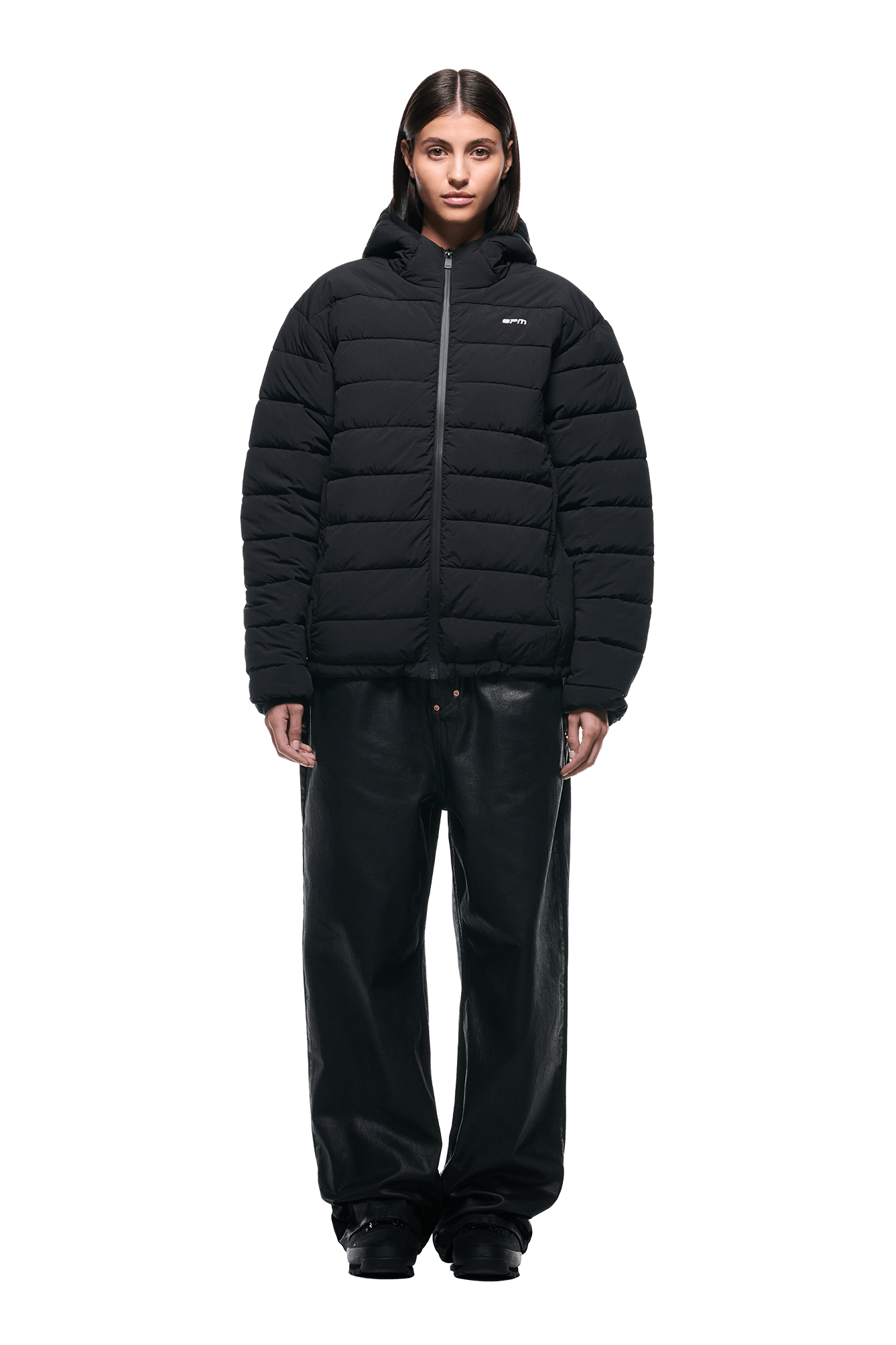 A person faces forward against a white background, wearing 6PMs LIGHT PUFFER JACKET BLACK with wide black pants and black shoes.
