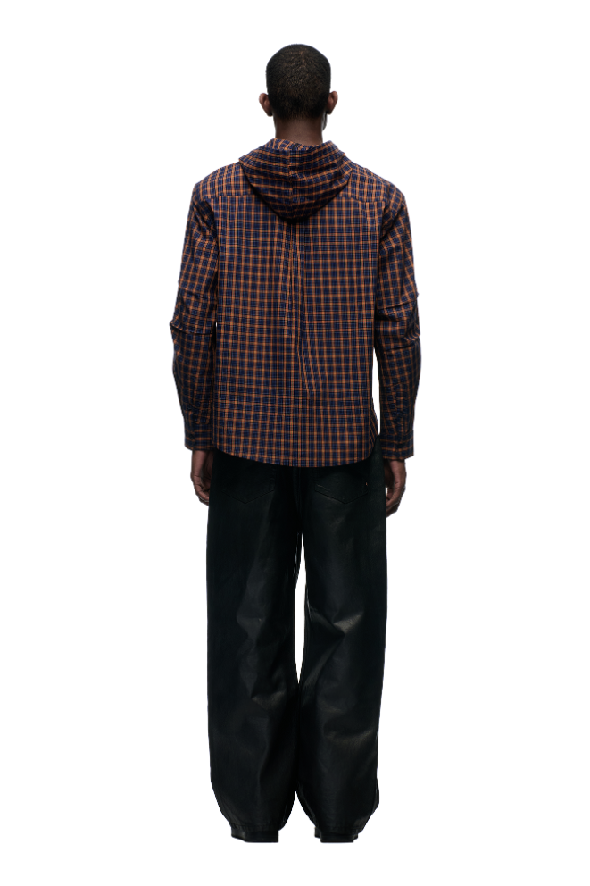 A person faces away, wearing the 6PM HOODED DRESS SHIRT in blue, orange, and black checks with loose, wide-leg black pants against a plain light background.