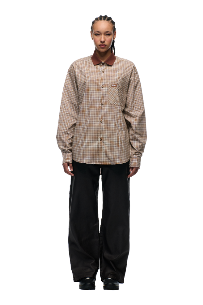 A person with braided hair wears the 6PM POLO COLLAR SHIRT COCOA BROWN, loose black pants, and black shoes, standing against a plain white background.