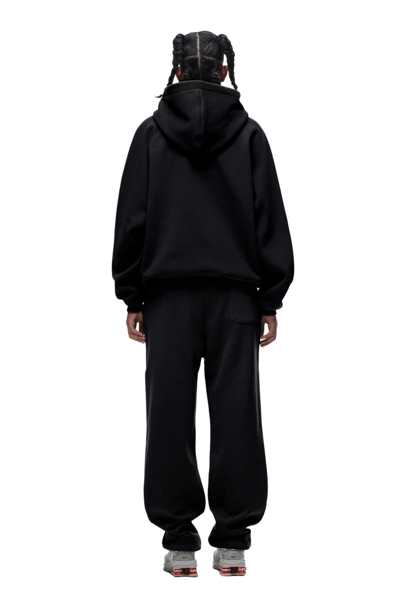 A person stands with their back to the camera, wearing HOODIE BLACK with raglan sleeves and a kangaroo pocket, black sweatpants, and sneakers. Transparent background makes this image perfect for everyday use.