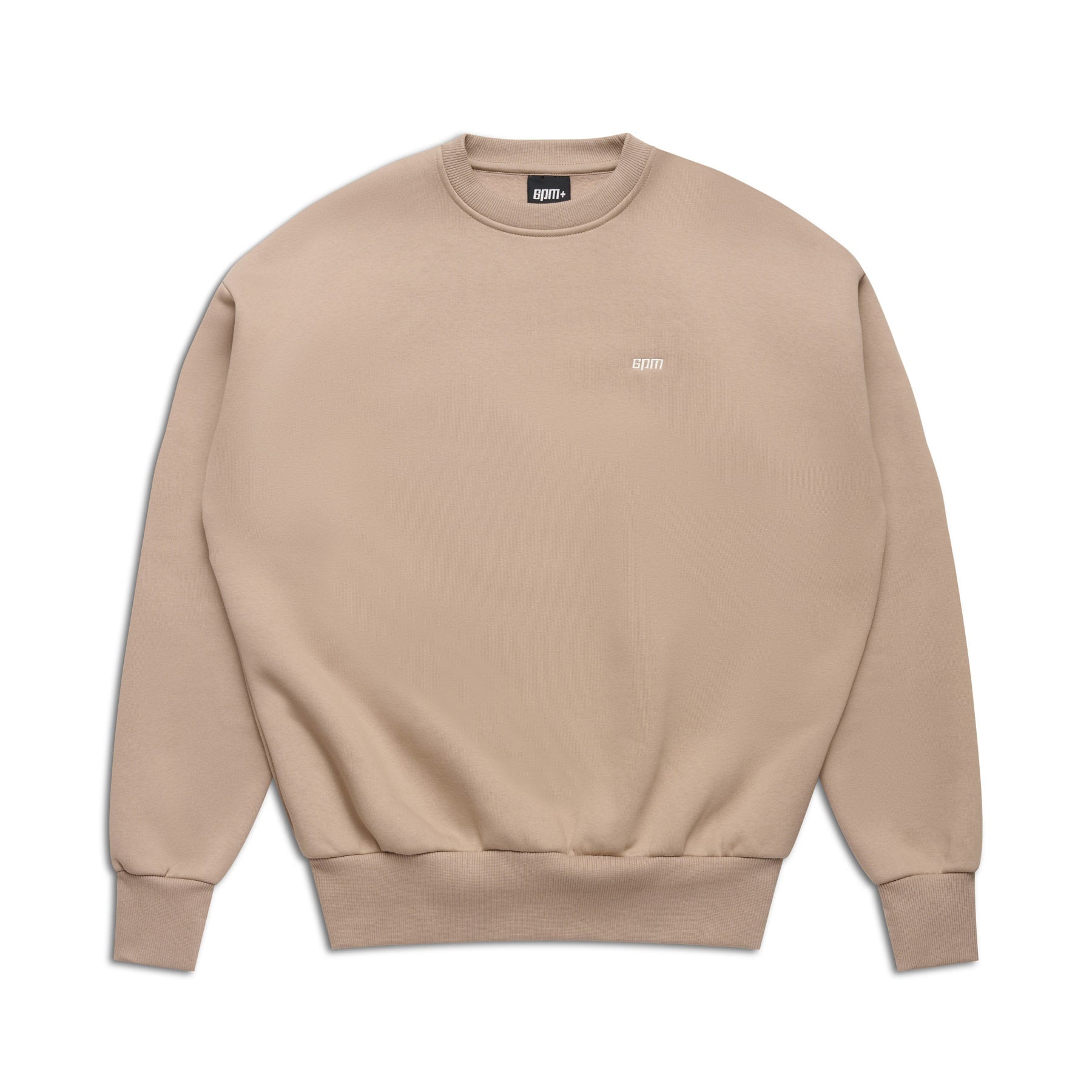 The 6PM CREWNECK MOCCA CREAM is a beige crewneck sweatshirt with long sleeves and ribbed collar, cuffs, and hem. It features a small white logo on the left chest, set against a white background.