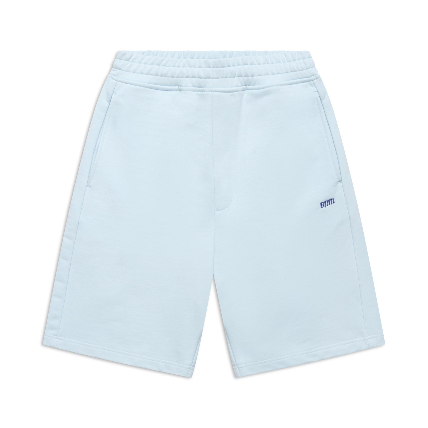 The 6PM+ SHORTS ICE BLUE feature a relaxed fit, elastic waistband, two side pockets, and a small blue 8PM logo on the left thigh. These light blue athletic shorts have a soft interior and are shown laid flat against a white background.