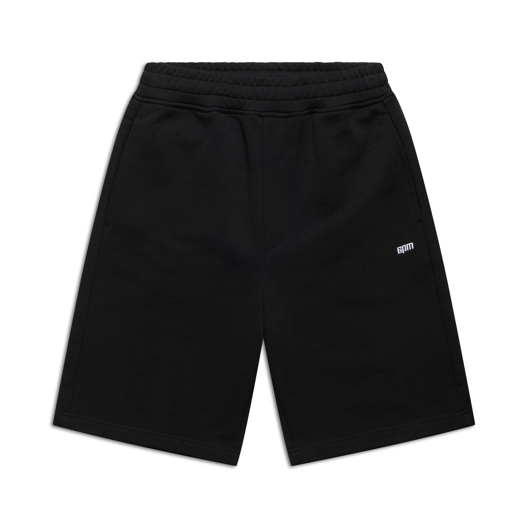 6PM+ SHORTS BLACK by 6PM: Relaxed-fit black athletic shorts with an elastic waistband, two side pockets, and a small white BOM logo on the left thigh. Perfect for lounging; shown laid flat on a white background.