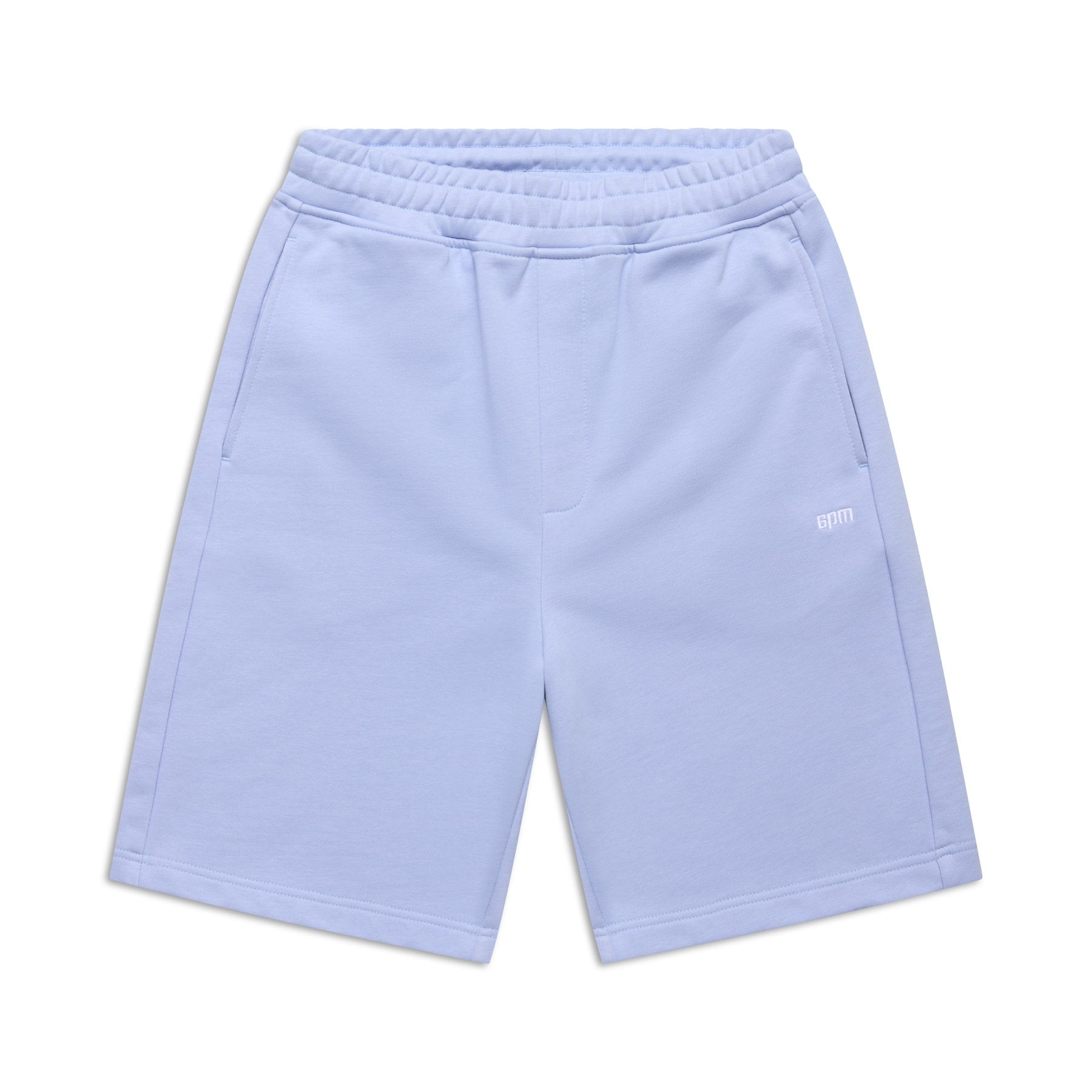 The 6PM+ SHORTS SOFT VIOLET are light blue athletic shorts featuring a relaxed fit, elastic waistband, two side pockets, and a small white logo on the left leg. Ideal for lounging, they’re shown laid flat on a white background.