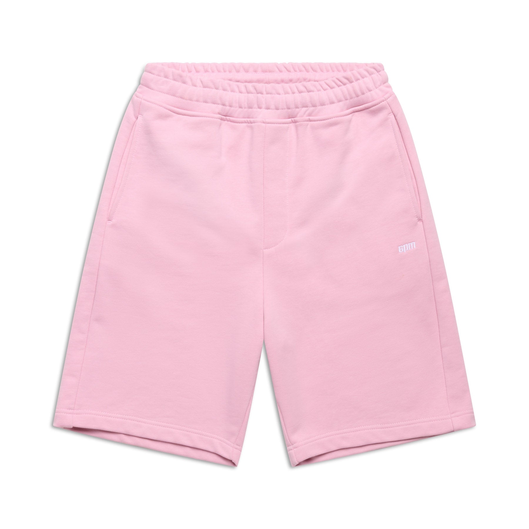 The 6PM+ SHORTS BABY PINK by 6PM feature a relaxed fit, elastic waistband, side pockets, and a subtle white logo on the left leg. The soft, casual shorts are shown laid flat on a white background.