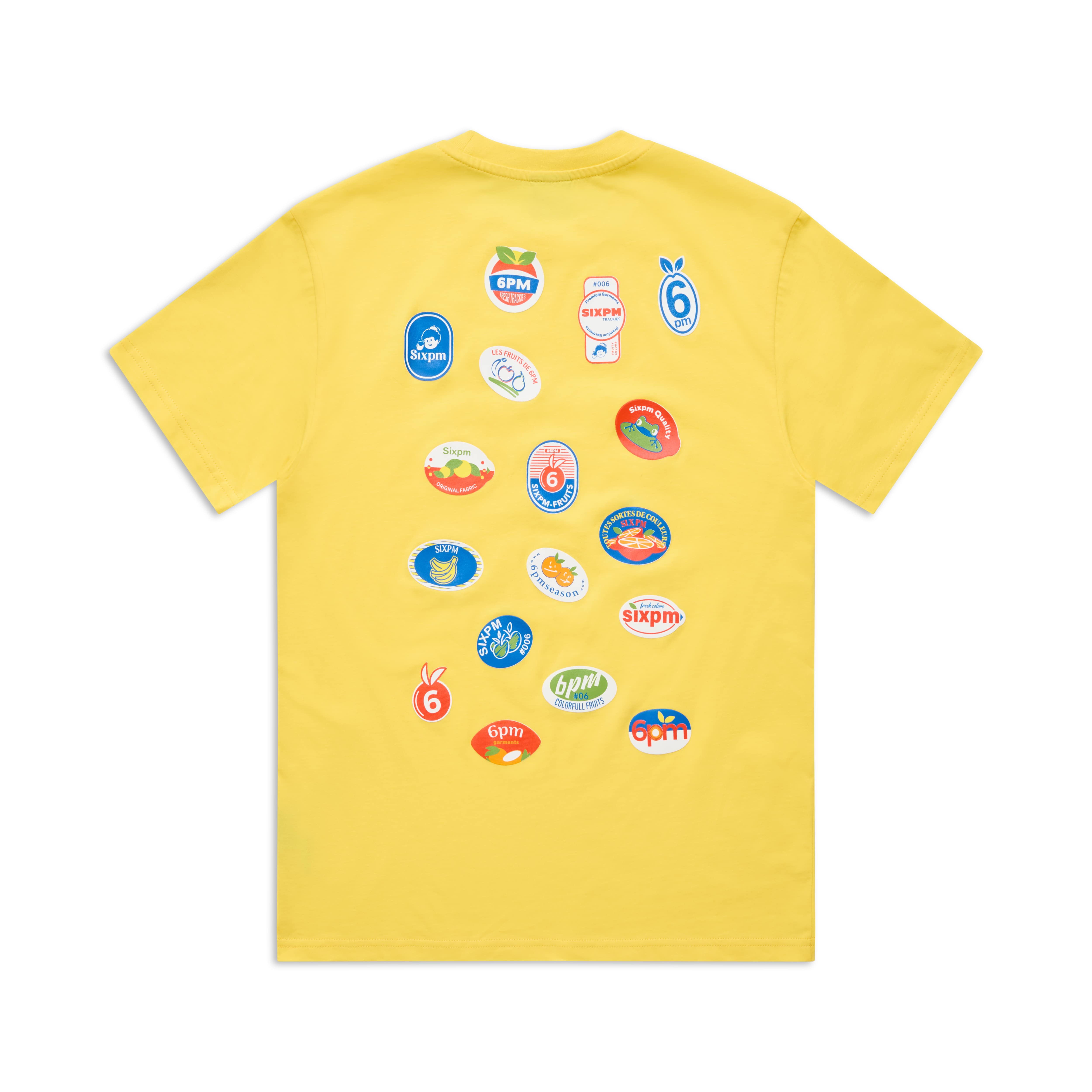 The BANANA STICKER TEE YELLOW by 6PM is a yellow T-shirt featuring playful, colorful graphic patches on the back with various shapes, numbers, and sixpm in different styles.