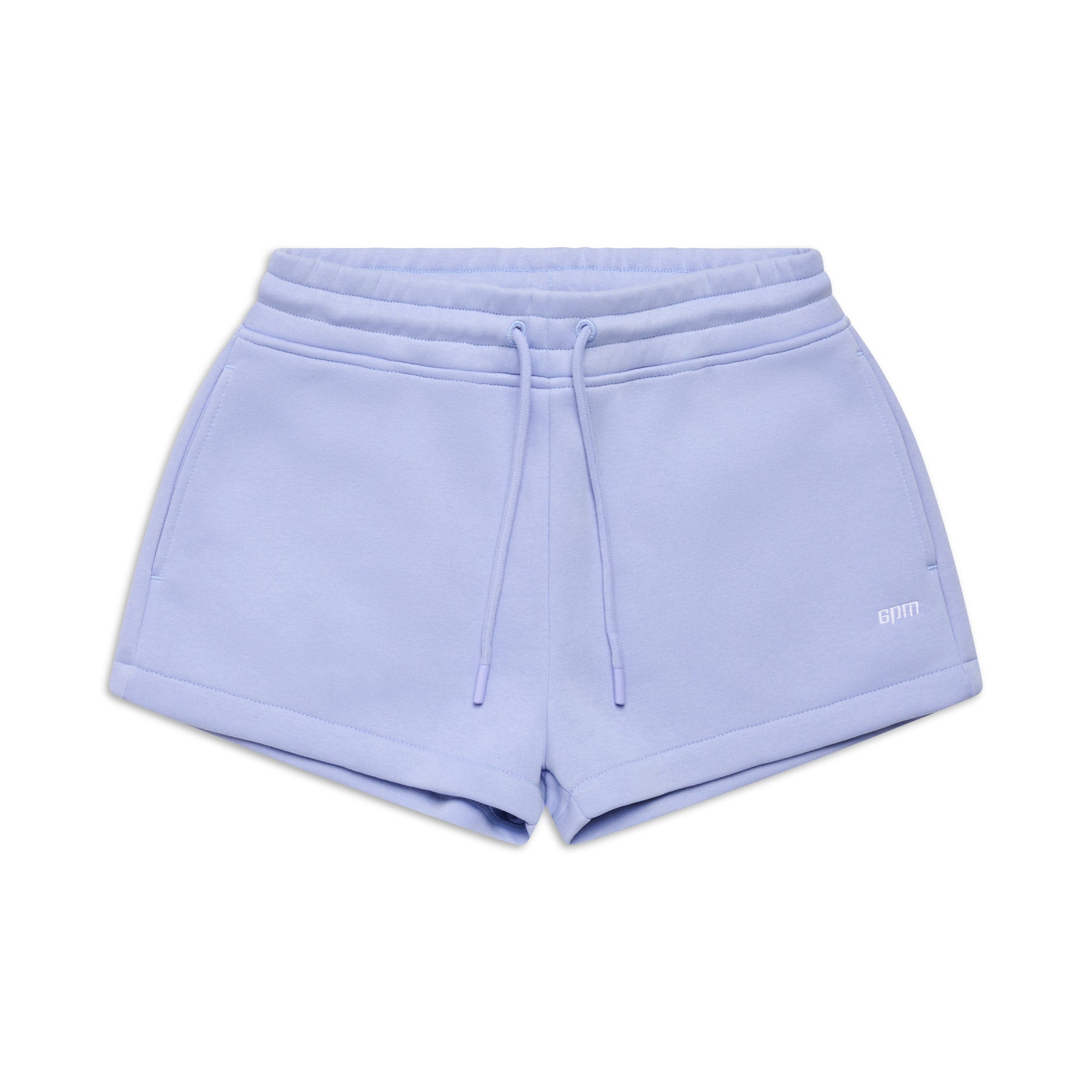 The 6PM WMNS SHORTS SOFT VIOLET feature an elastic waistband, drawstring ties, and side pockets. Displayed on a white background, these light purple shorts have a simple casual design with a small logo on the left leg.