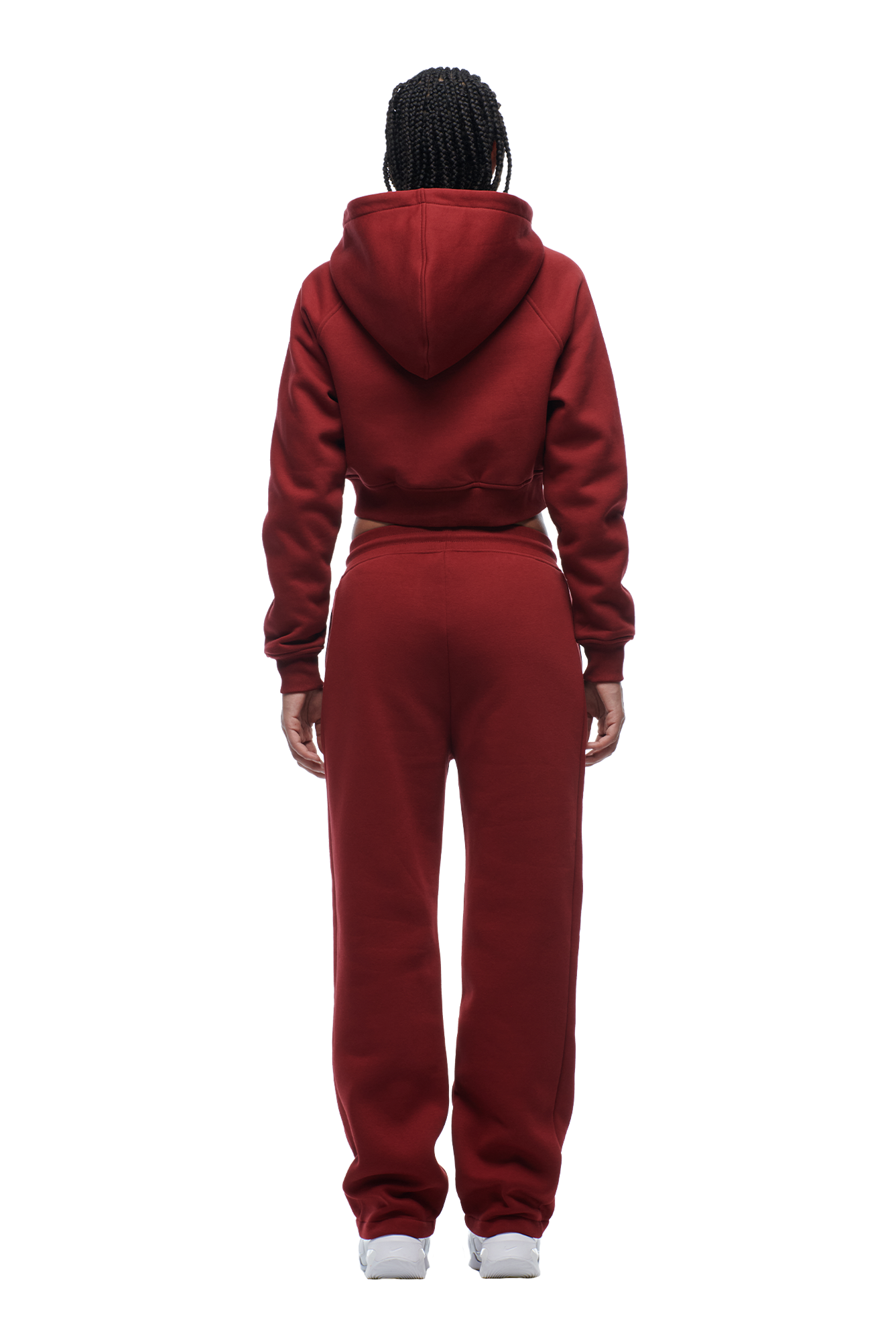 A person with braided hair, wearing the 6PM WMNS Cropped Zip Hoodie in Wine Red, stands facing away from the camera against a white background.