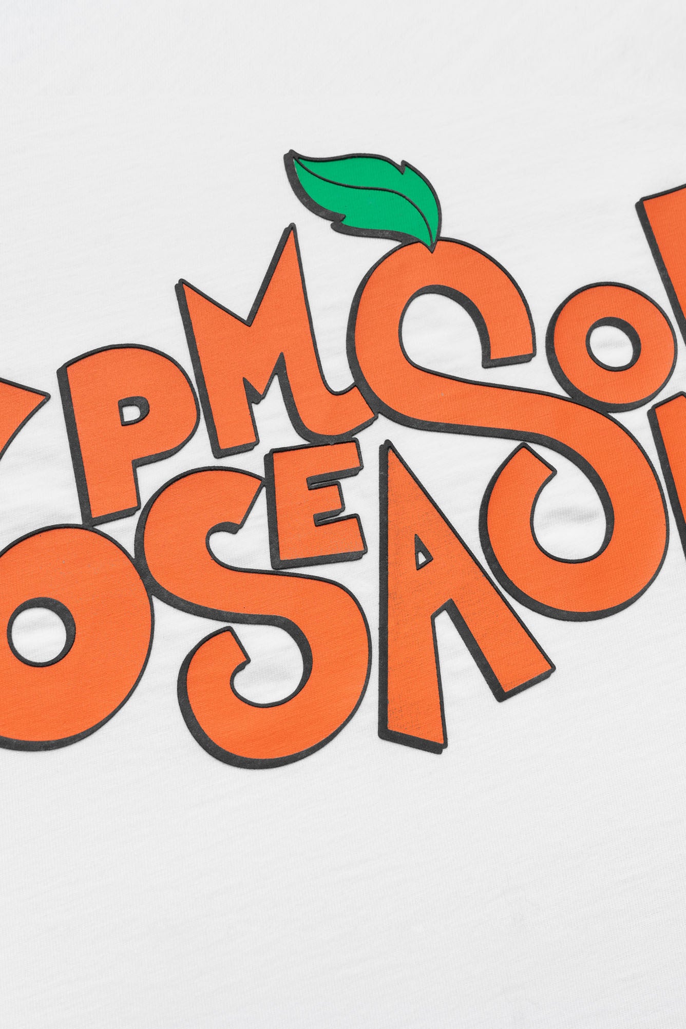 Bold, playful orange letters outlined in black spell out "PMP SOSAE" with a green leaf atop the first S, displayed on a white SODA PLAY T-SHIRT from 6PM.