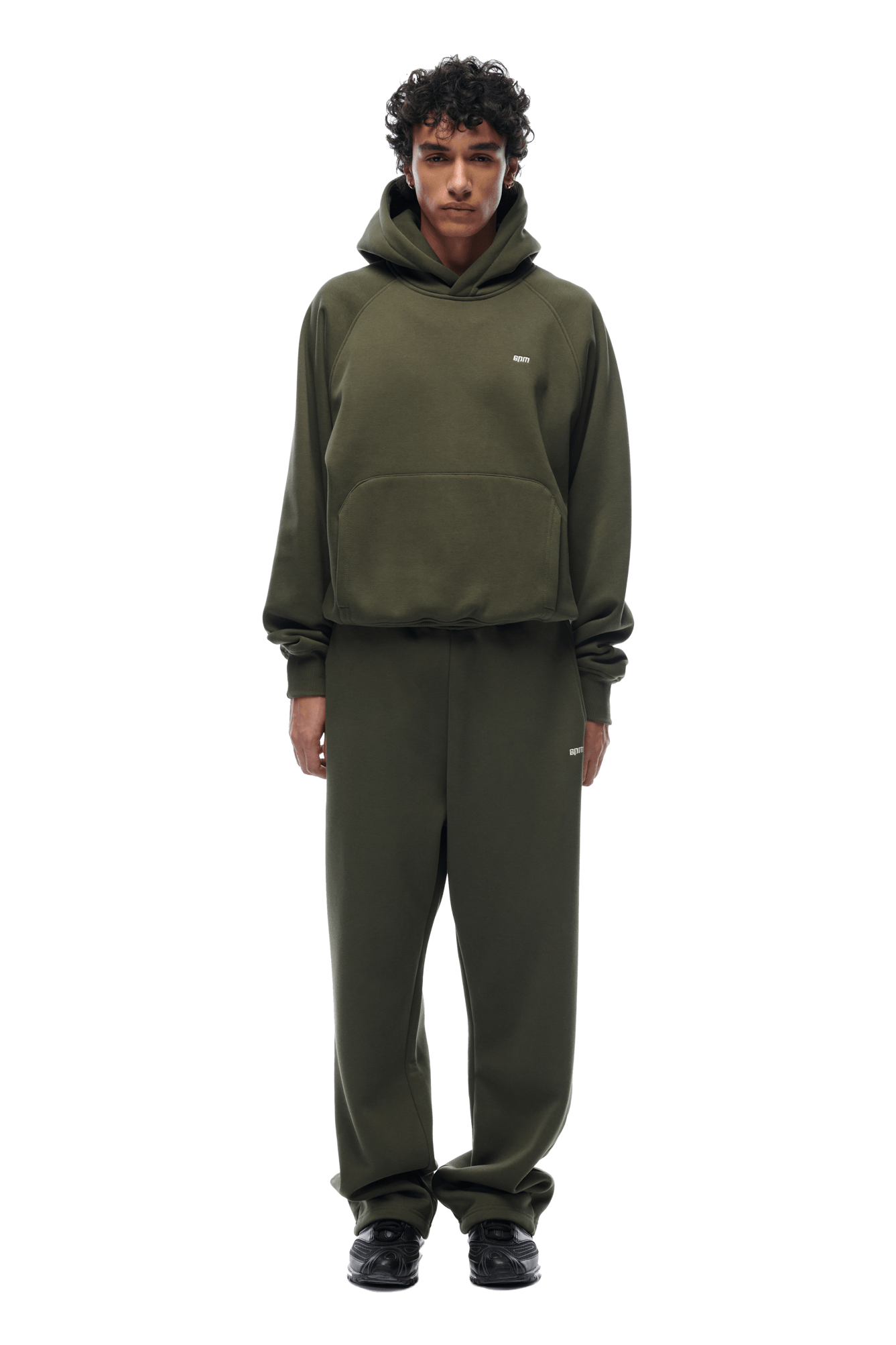 A person faces forward in the 6PM HOODIE FOREST NIGHT and matching sweatpants with black shoes, perfect for everyday wear. The background is transparent.