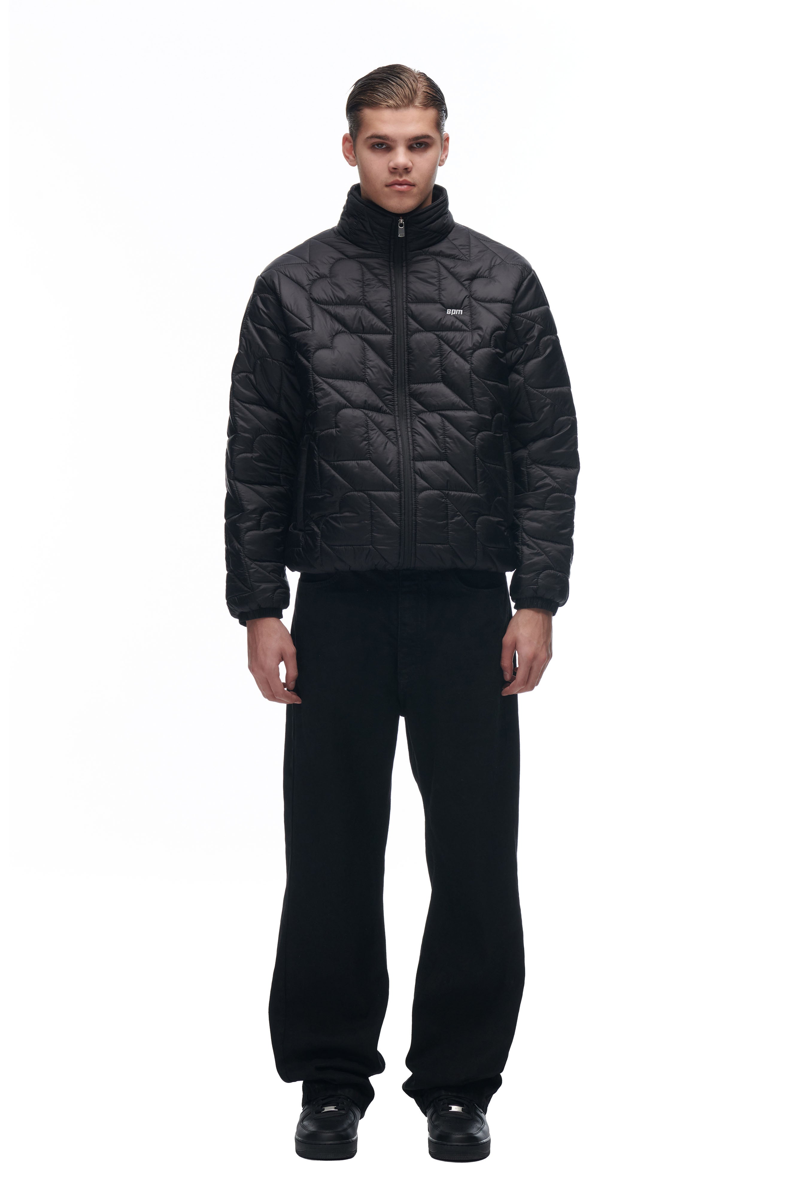 A person stands facing forward in a black 6PM HEART SPRING JACKET, paired with black pants and shoes, against a plain white background.