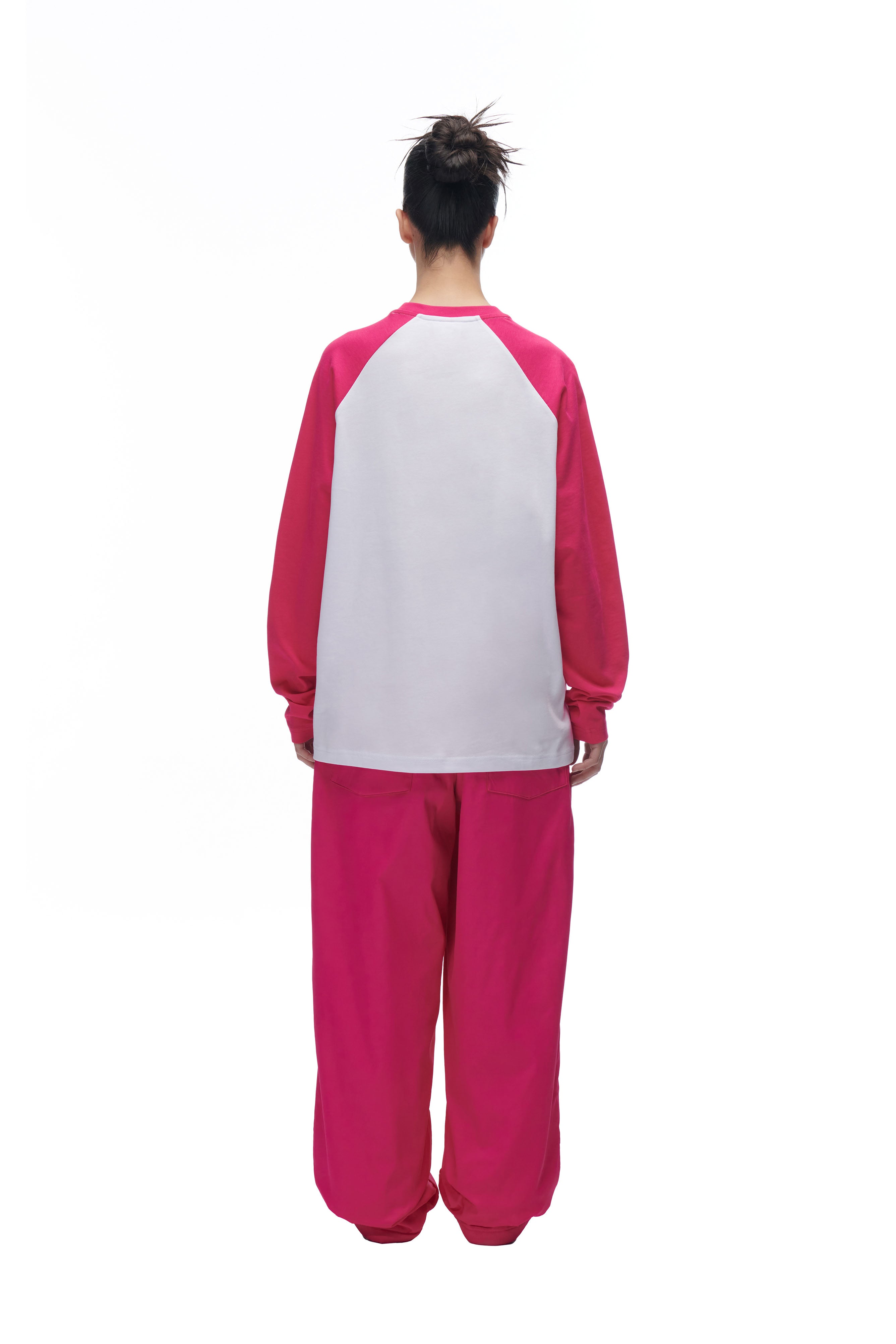 A person wearing the 6PM LH LONGSLEEVE WHITE/PINK pajamas.