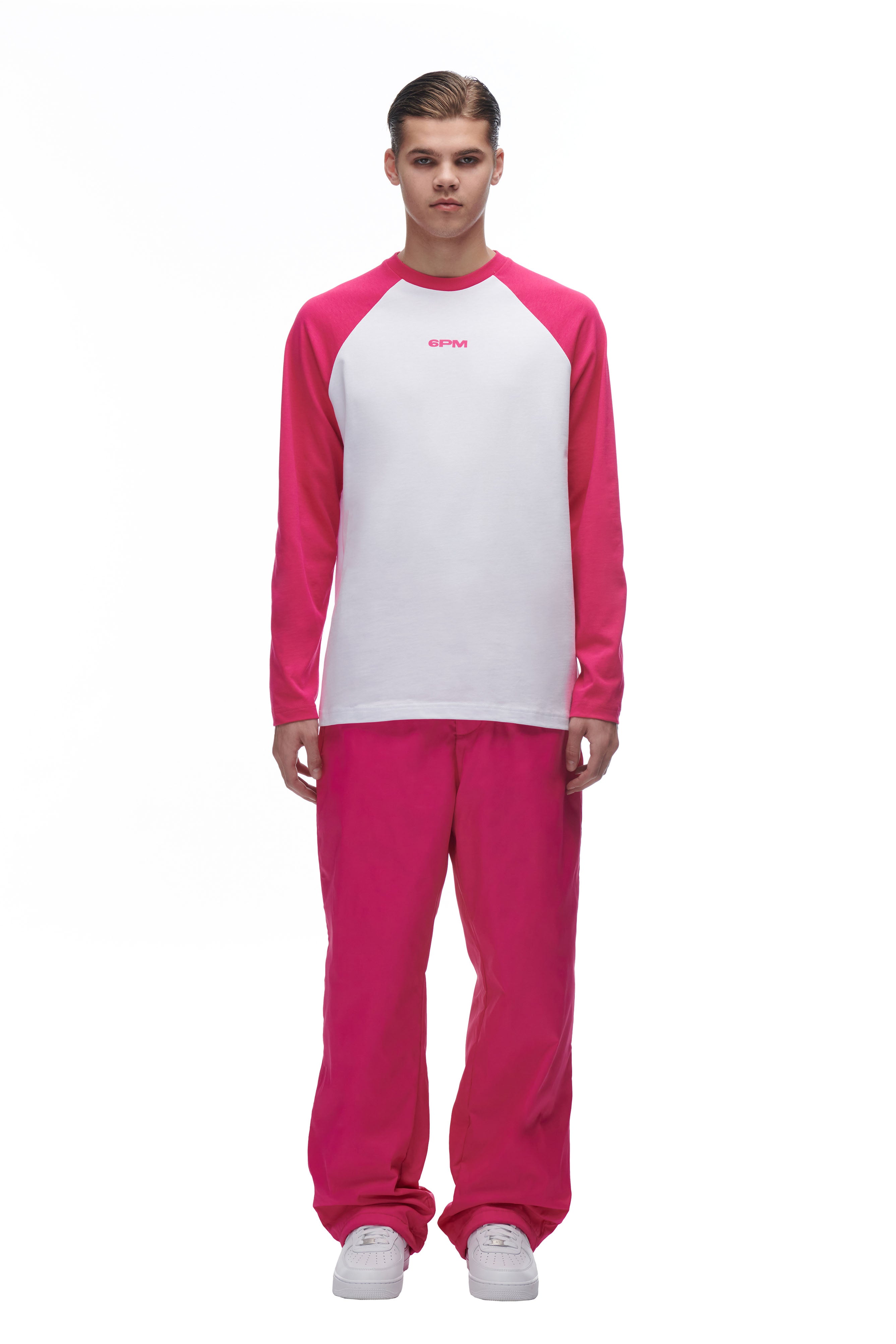 A man wearing the 6PM LH LONGSLEEVE WHITE/PINK shirt.