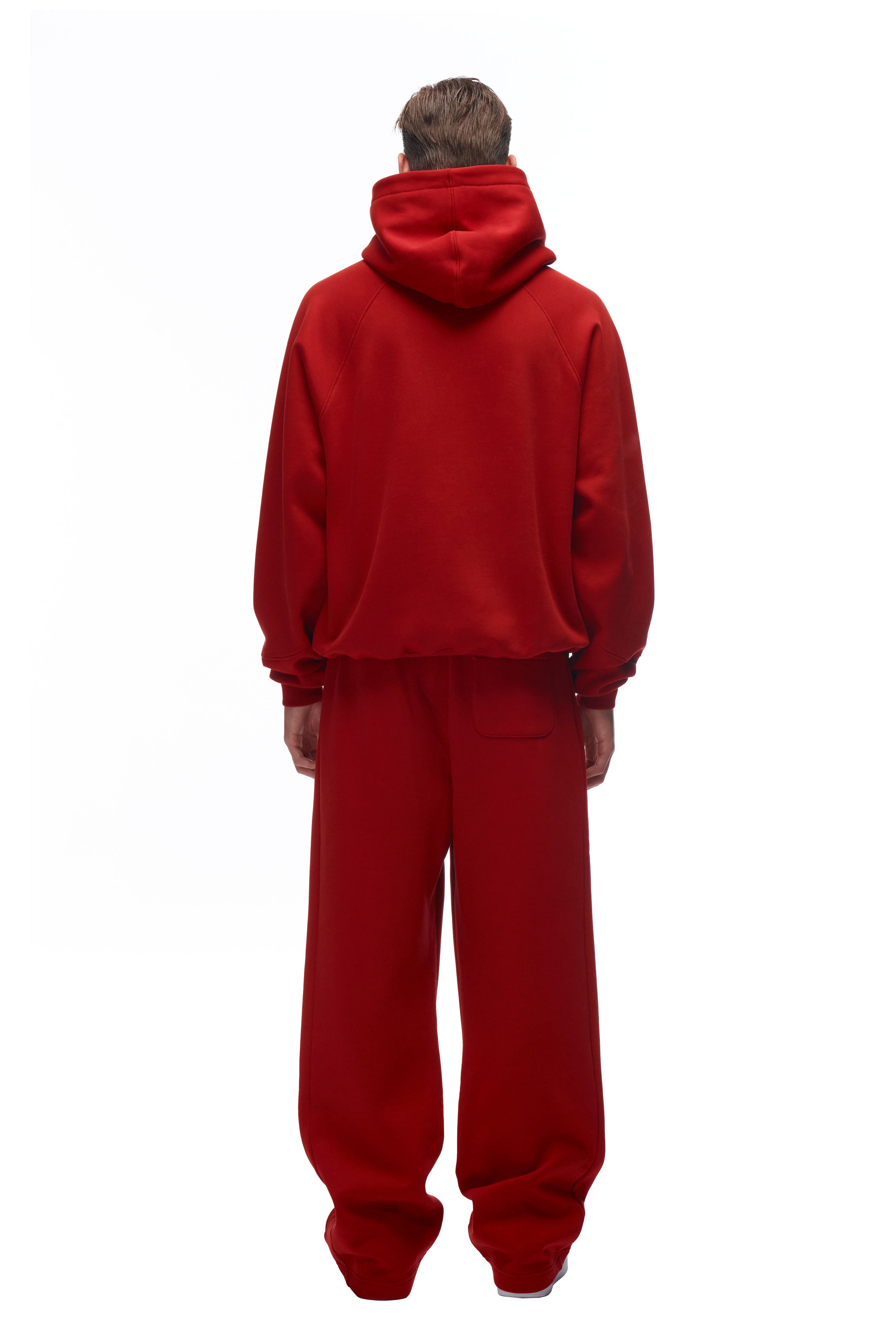 A person faces away from the camera, wearing the 6PM LH HOODIE RED with matching red baggy pants, set against a plain white background.