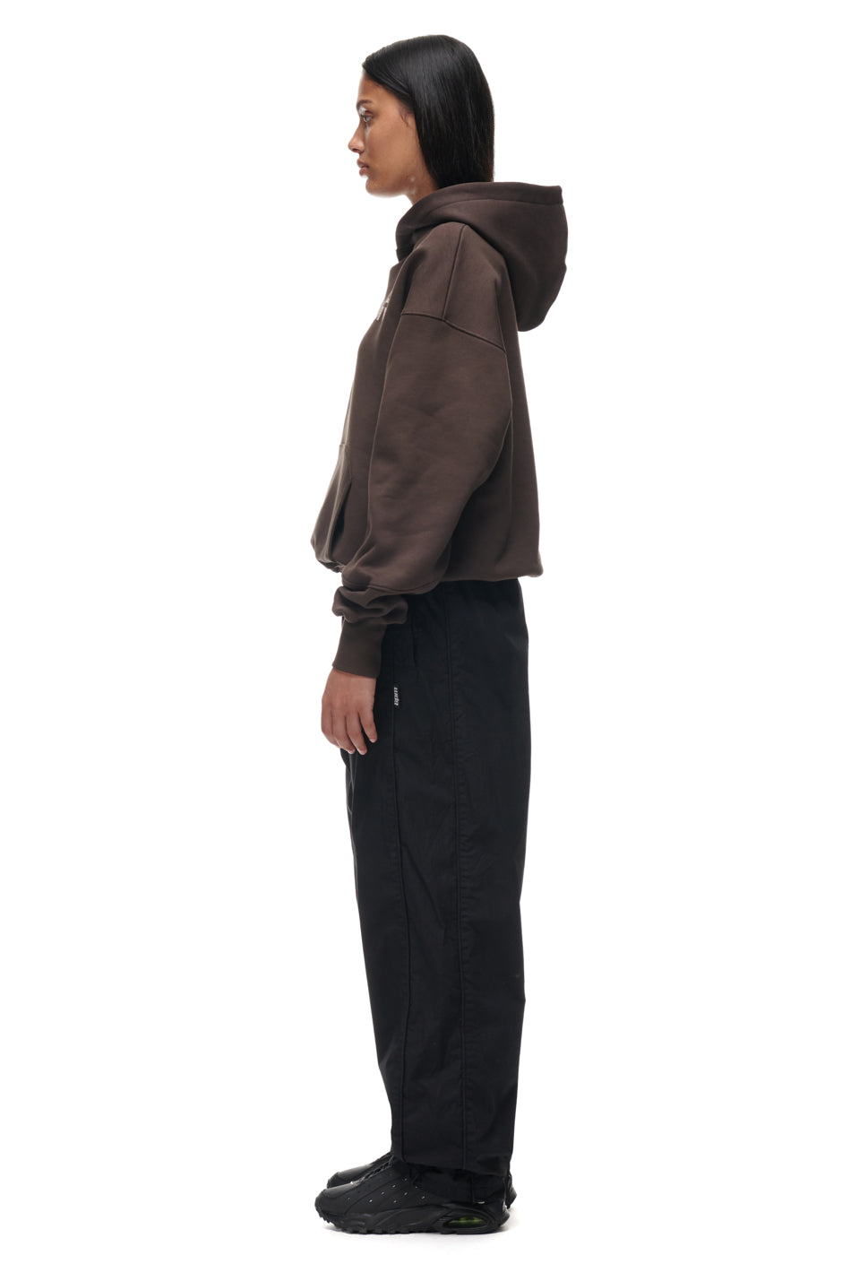 A person wearing the 6PM TILES HOODIE BROWN.