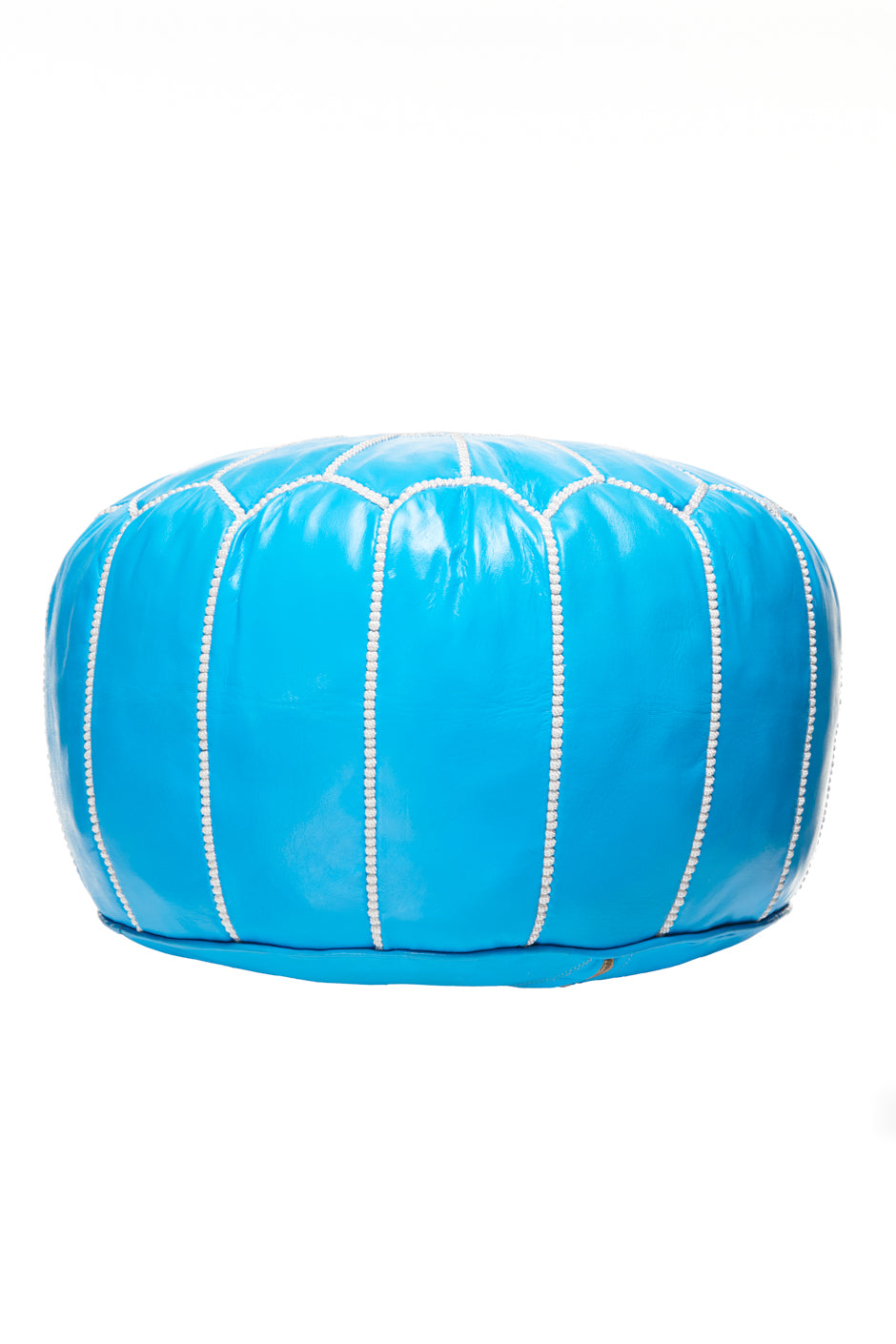 The MEDINA SEAT CUSHION BLUE by 6PM is a bright blue, round leather pouf with white stitched vertical seams, displayed against a plain white background.