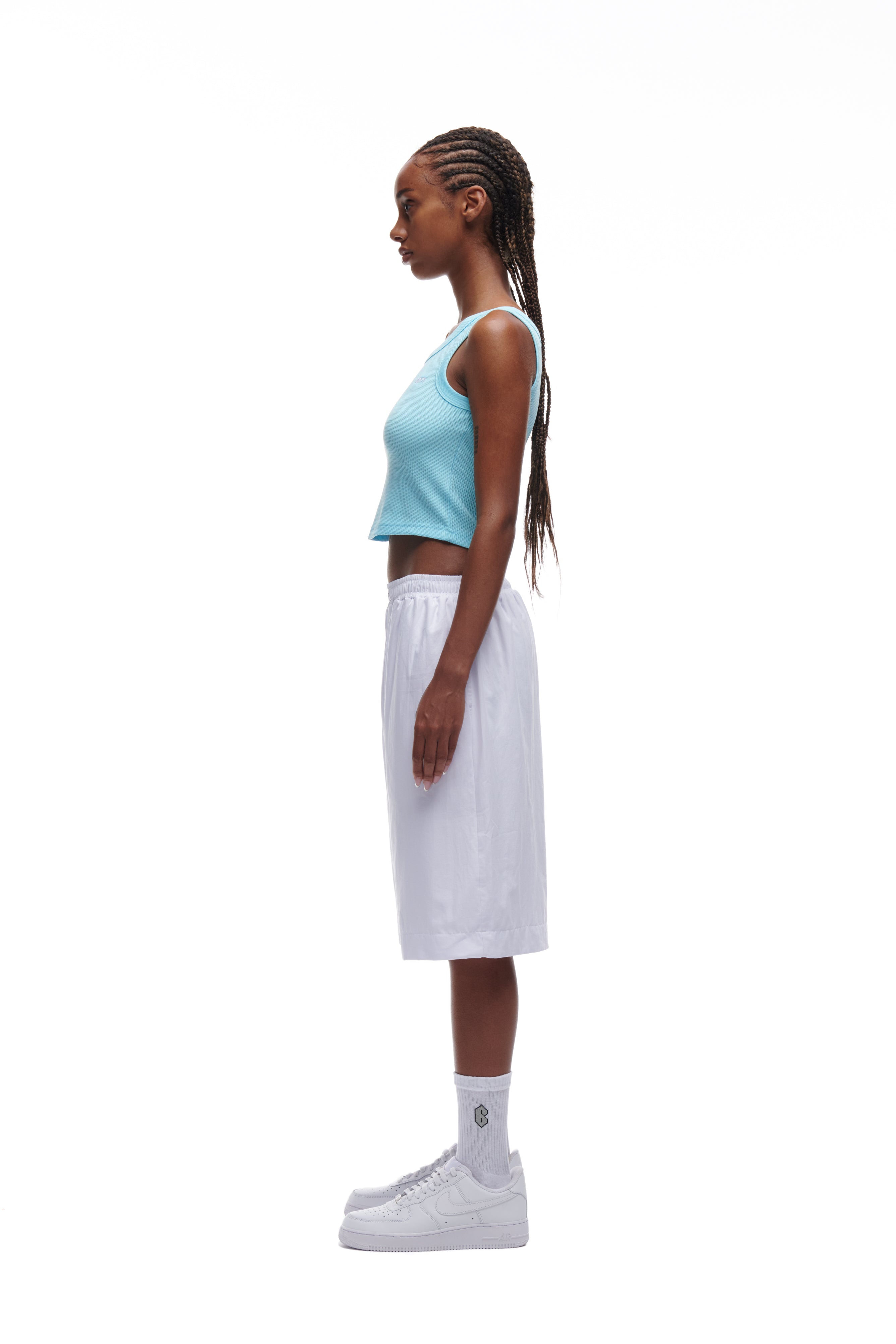 A woman in the 6PM WAFFLE KNIT CROP TOP BABY BLUE.