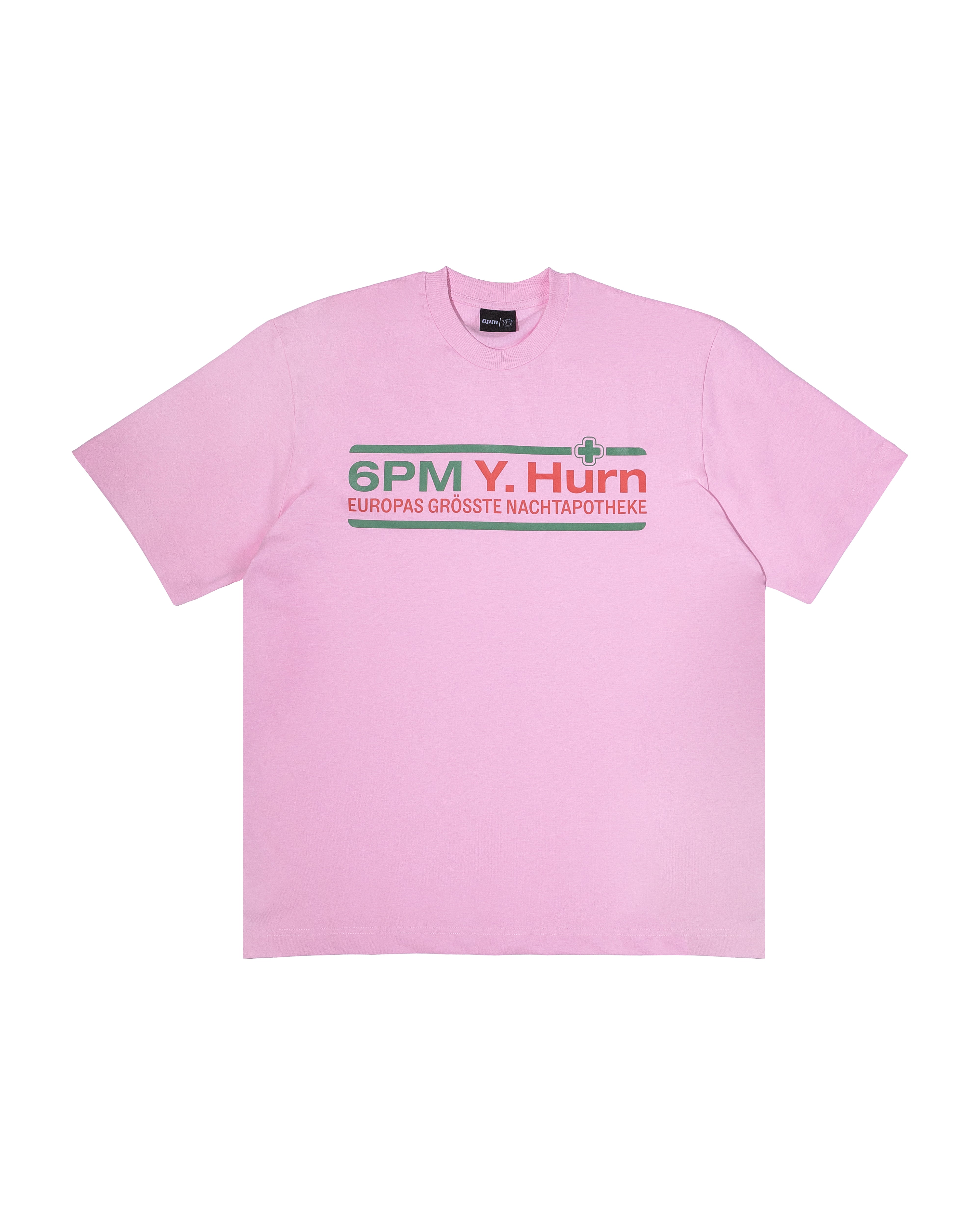 The OG PARACETAMOL T-SHIRT PINK by 6PM features light pink short sleeves and "6PM Y. Hurn EUROPAS GROSSTE NACHTAPOTHEKE" in green, red, and gray on the chest, plus a small green cross graphic.