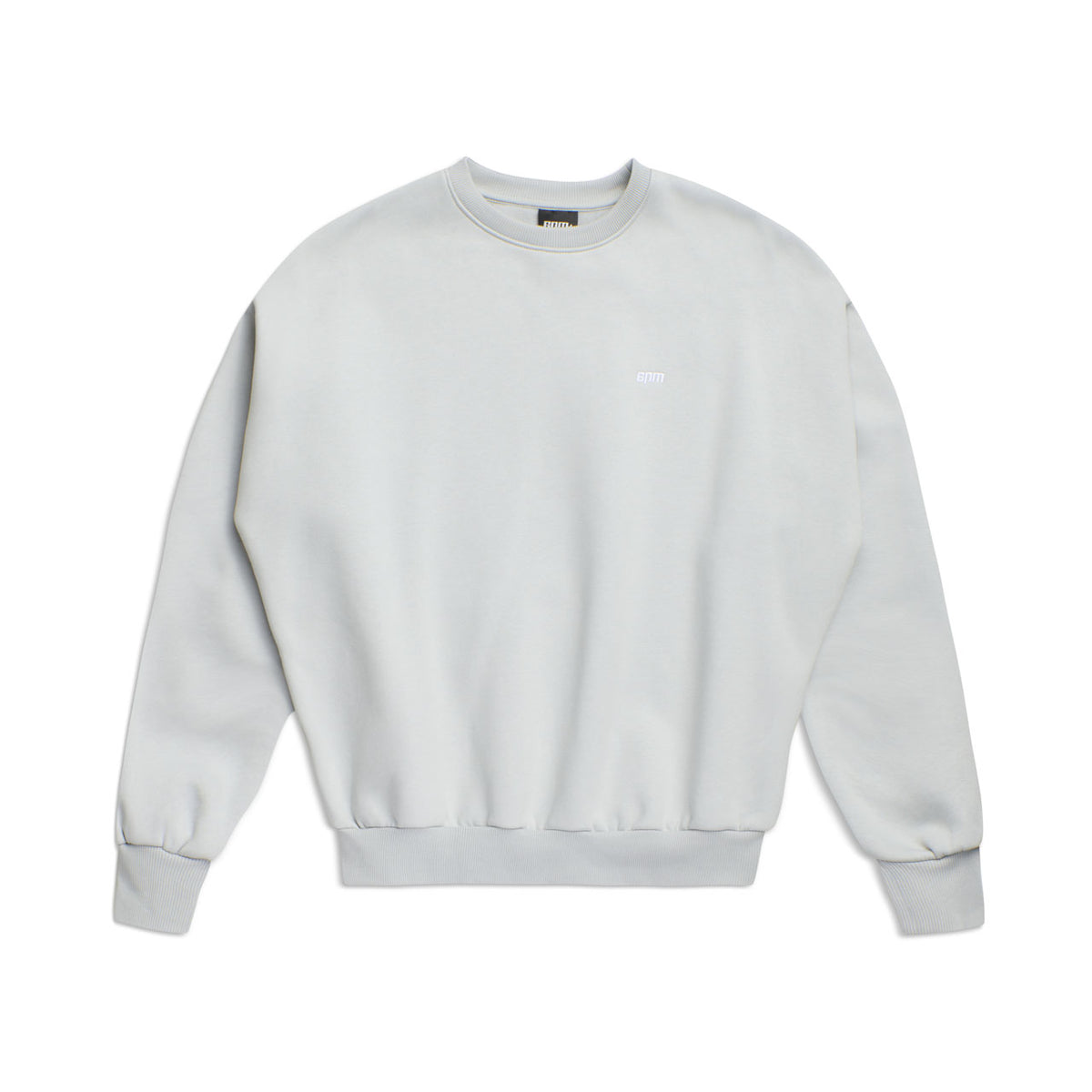 The 6PM CREWNECK SMOKE GREY is a light gray, boxy-fit sweatshirt featuring long sleeves, ribbed cuffs and hem, and a small logo on the left chest for a simple, minimalistic look.