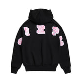 The 6PM DOT CAMO LETTER HOODIE BLACK features large pink and white varsity-style letters scattered on the back and sleeves. Displayed flat on a white background.