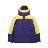The 6PM COACH PUFFER COAT BLUE is a hooded winter jacket with blue color blocks, front zipper, and multiple pockets for storage.