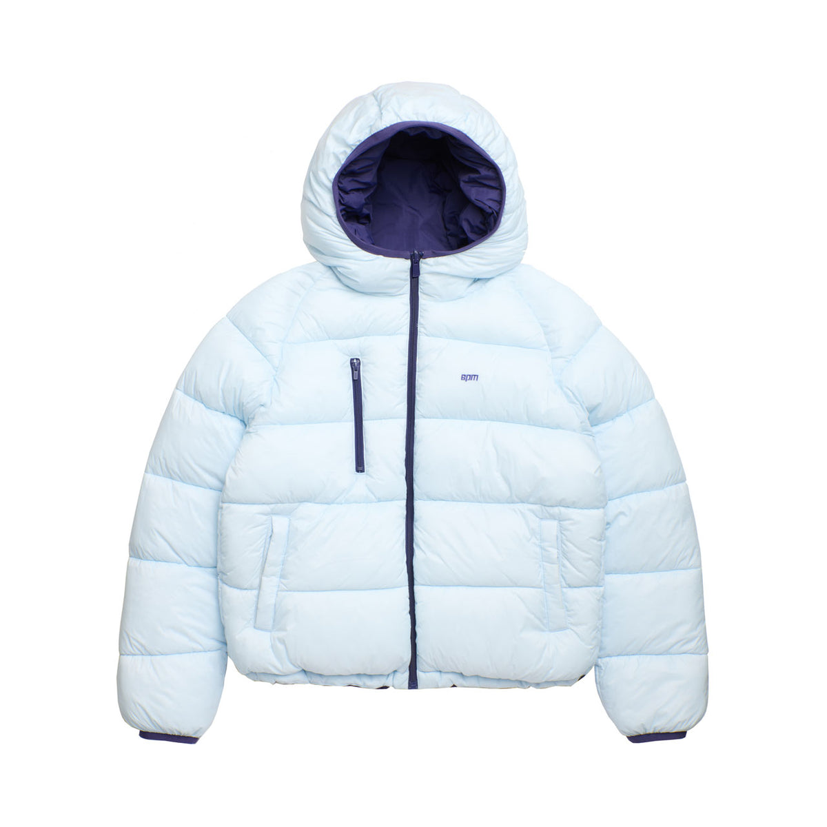 The 6PM REVERSIBLE PUFFER JACKET BLUE features a light blue exterior, dark blue interior lining, hood, front zipper, two side pockets, one chest pocket, and a small stitched logo on the chest.
