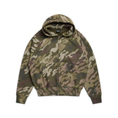 The 6PM DOT CAMO ZIP HOODIE GREEN features a green, brown, and beige camouflage pattern, front pocket, zip closure, and hood, shown laid flat on a white background.