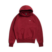 The HOODIE WINE RED features maroon raglan sleeves, a kangaroo pocket, and small white chest text. Shown laid flat on a white background, it’s perfect for everyday wear.