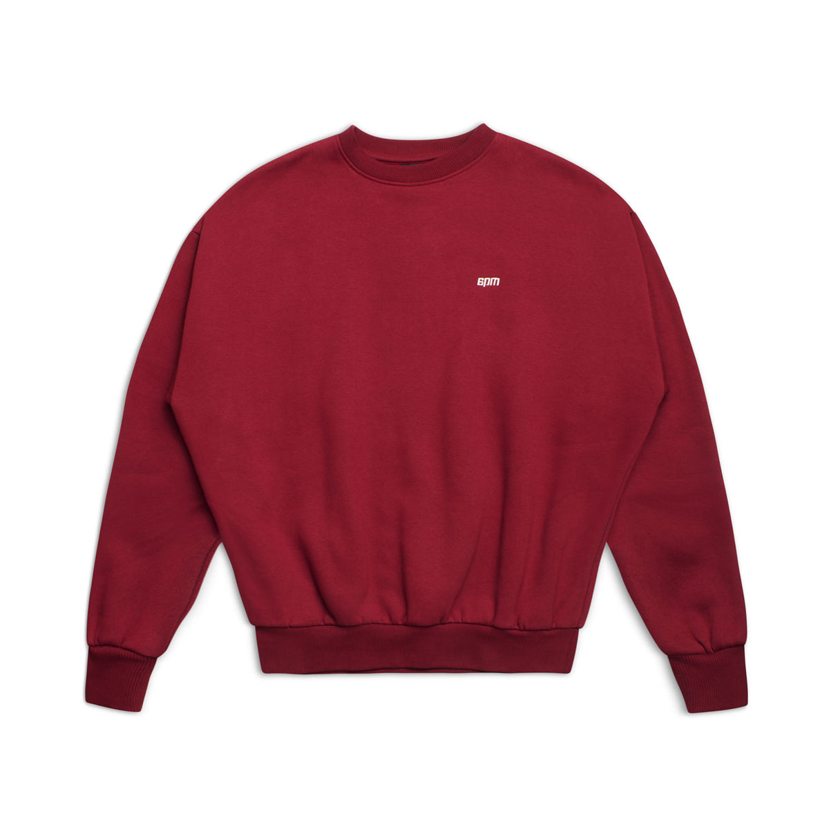 The 6PM CREWNECK WINE RED is a boxy fit crewneck sweatshirt with long sleeves, ribbed cuffs, a tight hem, and a small white embroidered logo on the chest. It is shown laid flat on a white background.