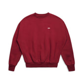 The 6PM CREWNECK WINE RED is a boxy fit crewneck sweatshirt with long sleeves, ribbed cuffs, a tight hem, and a small white embroidered logo on the chest. It is shown laid flat on a white background.