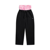 The 6PM BOXERS OPEN LEG JOGGER BLACK features a drawstring waist and a visible pink patterned elastic waistband, shown against a white background.