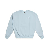 The 6PM CREWNECK ICE BLUE sweatshirt features ribbed trims, long sleeves, and a small dark blue logo on the left chest, shown on a white background.