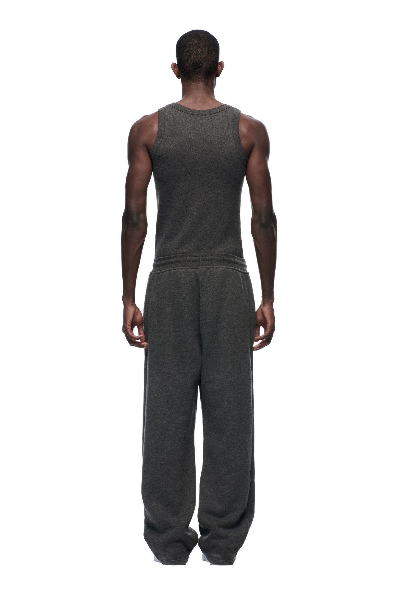 A man faces away from the camera wearing 6PM’s OPEN LEG JOGGER DARK GREY MELANGE against a plain white background.