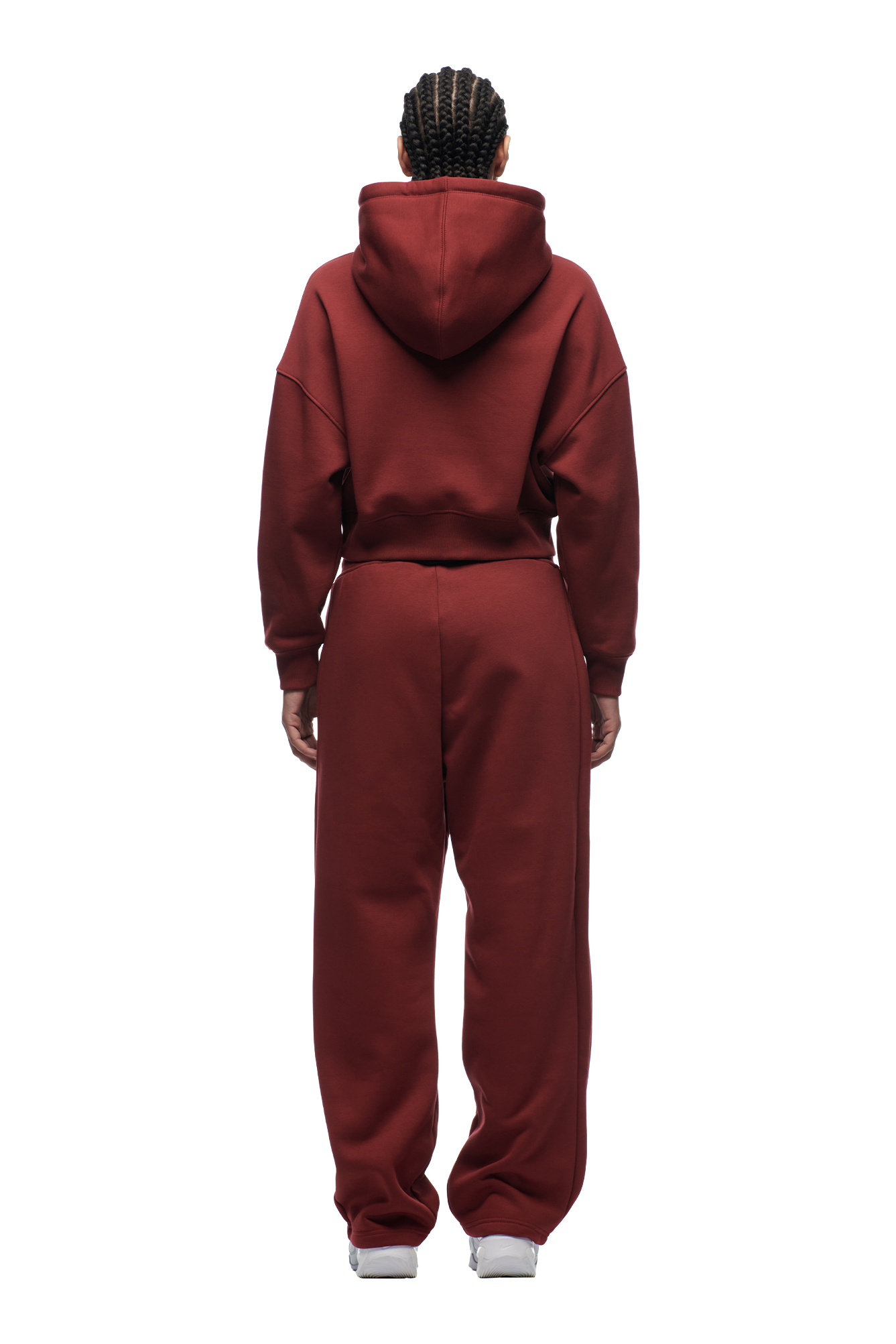 A person with braided hair, seen from behind, wears the 6PM WMNS Cropped Hoodie Wine Red and matching sweatpants with white sneakers, standing against a plain white background.