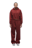 A woman faces forward against a plain white background, wearing the 6PM WMNS CROPPED HOODIE WINE RED with matching sweatpants and white sneakers; the relaxed, comfortable set features a cropped hoodie.