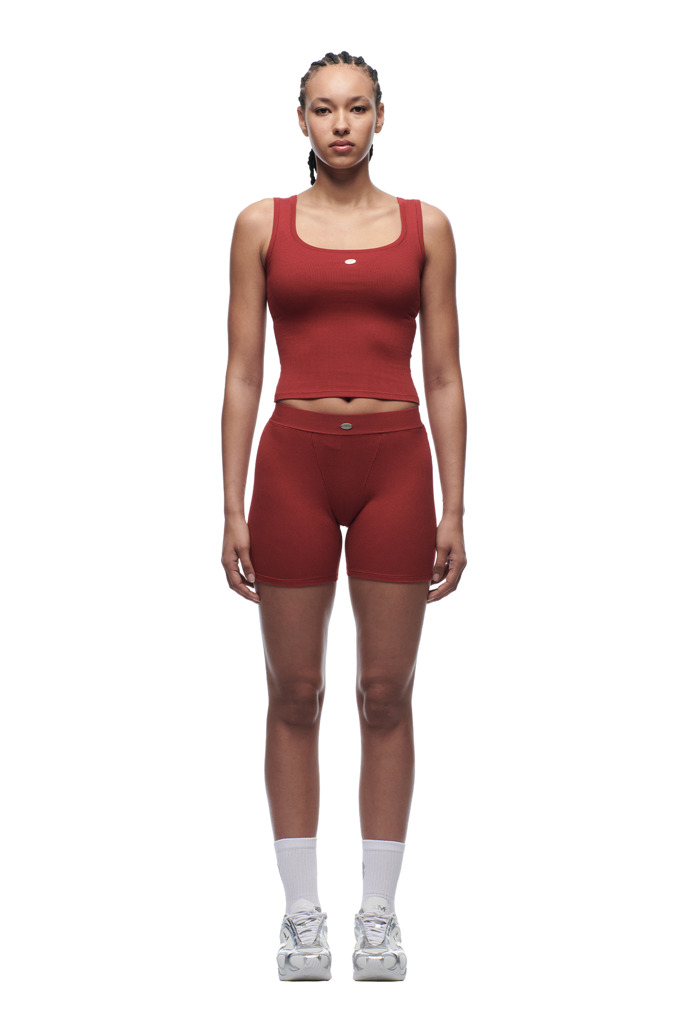 A woman faces forward against a white background, wearing 6PM WMNS BOXER SHORTS in wine red with a matching tank top, paired with white socks and sneakers.